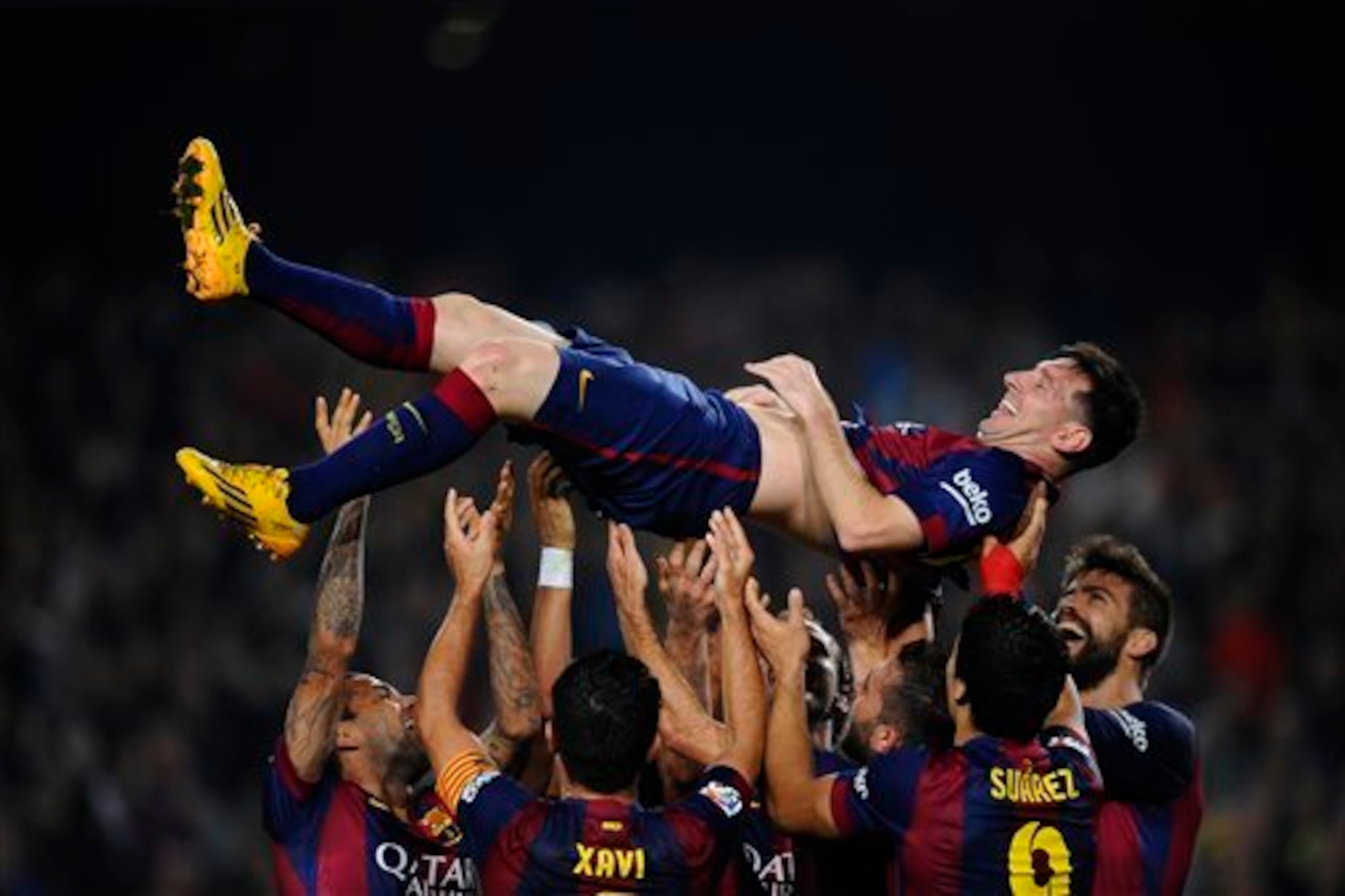 Messi is raised aloft after breaking Telmo Zarra's La Liga goal record