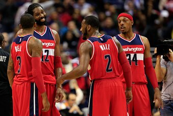 WASHINGTON, DC - NOVEMBER 21: Nene Hilario #42 talks with teammates Bradley Beal #3, John Wall #2, and Paul Pierce #34 of the Washington Wizards during the closing moments of the Wizards 91-78 win over the Cleveland Cavaliers at Verizon Center on November