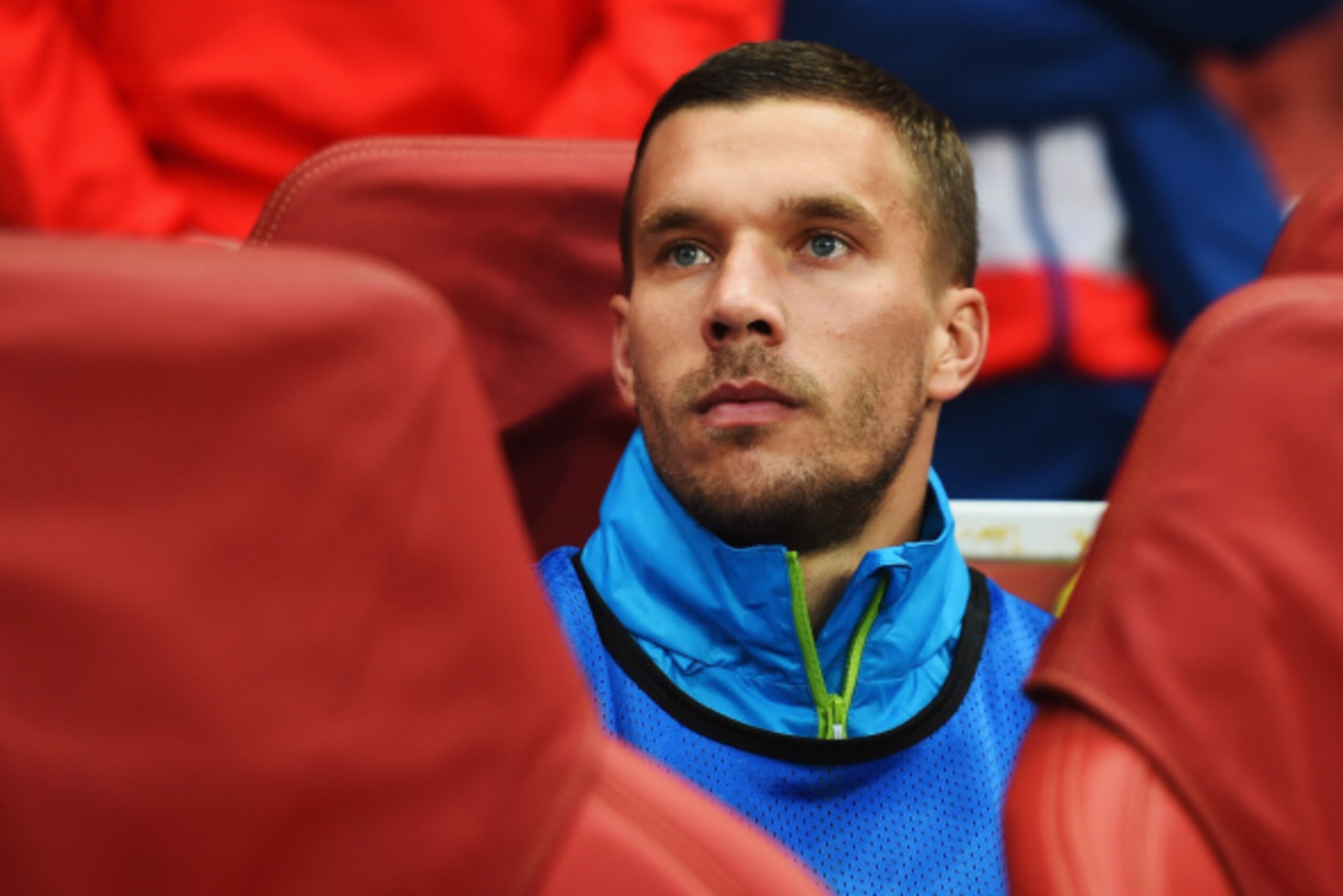 LONDON, ENGLAND - AUGUST 27: Lukas Podolski of Arsenal looks on from the substitutes bench before the UEFA Champions League Qualifier 2nd leg match between Arsenal and Besiktas at the Emirates Stadium on August 27, 2014 in London, United Kingdom.  (Photo 