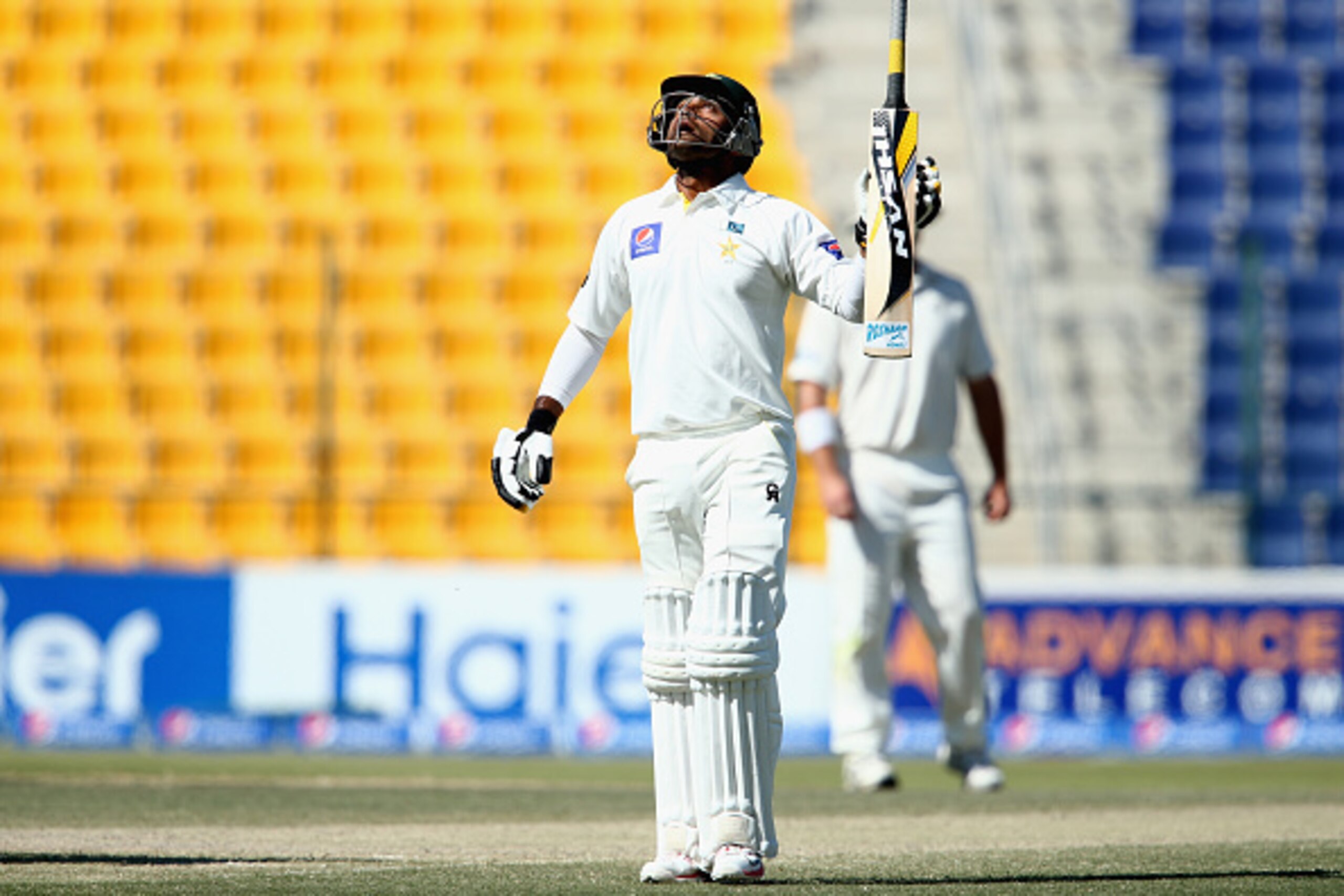 ABU DHABI, UNITED ARAB EMIRATES - NOVEMBER 12:  Mohammad Hafeez of Pakistan celebrates reaching his century during day four of the first test between Pakistan and New Zealand at Sheikh Zayed Stadium on November 12, 2014 in Abu Dhabi, United Arab Emirates.