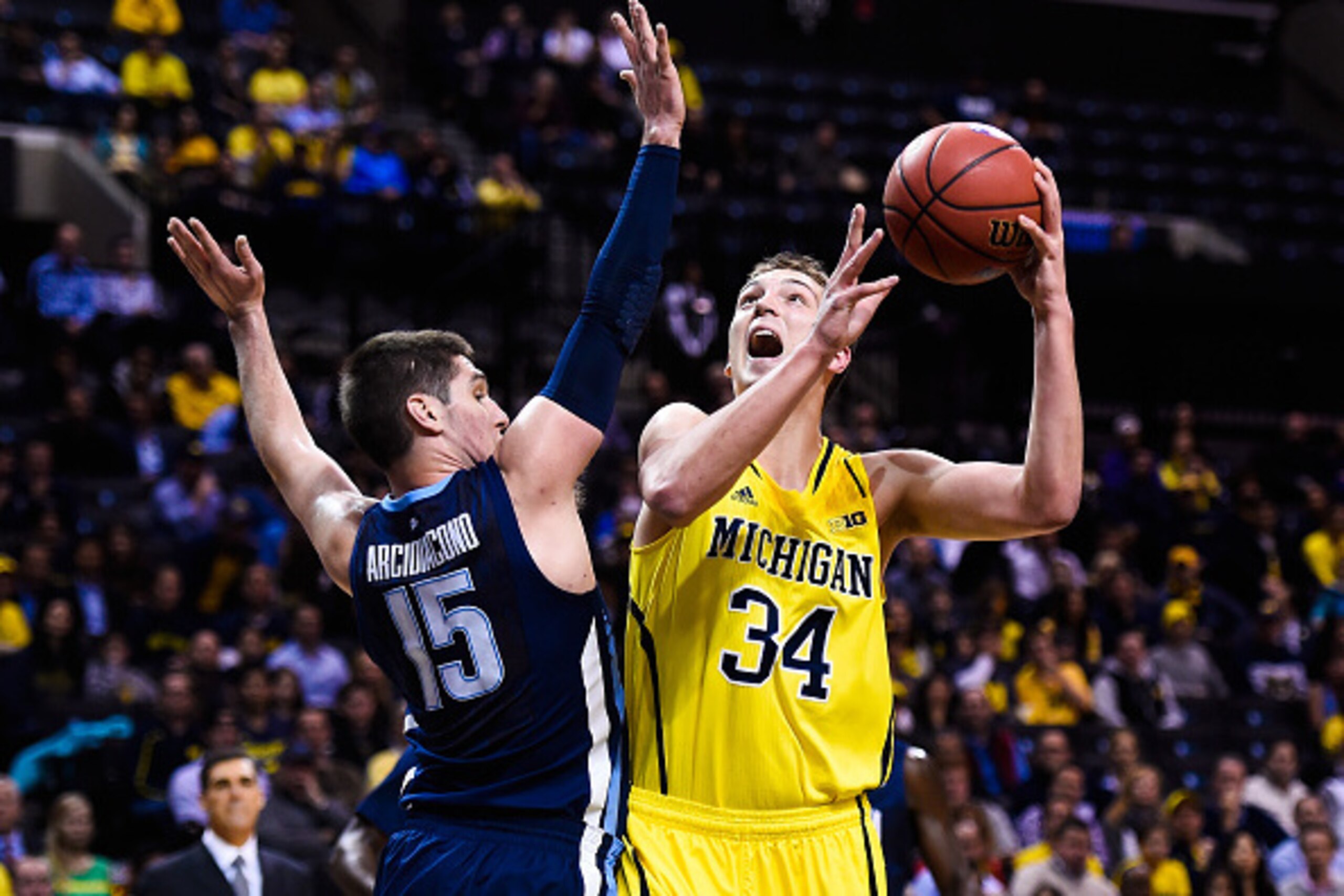 NEW YORK, NY - NOVEMBER 25:  Mark Donnal #34 of the Michigan Wolverines attempts a shot over Ryan Arcidiacono #15 of the Villanova Wildcats in the first half at the Barclays Center on November 25, 2014 in the Brooklyn borough of New York City.  (Photo by 