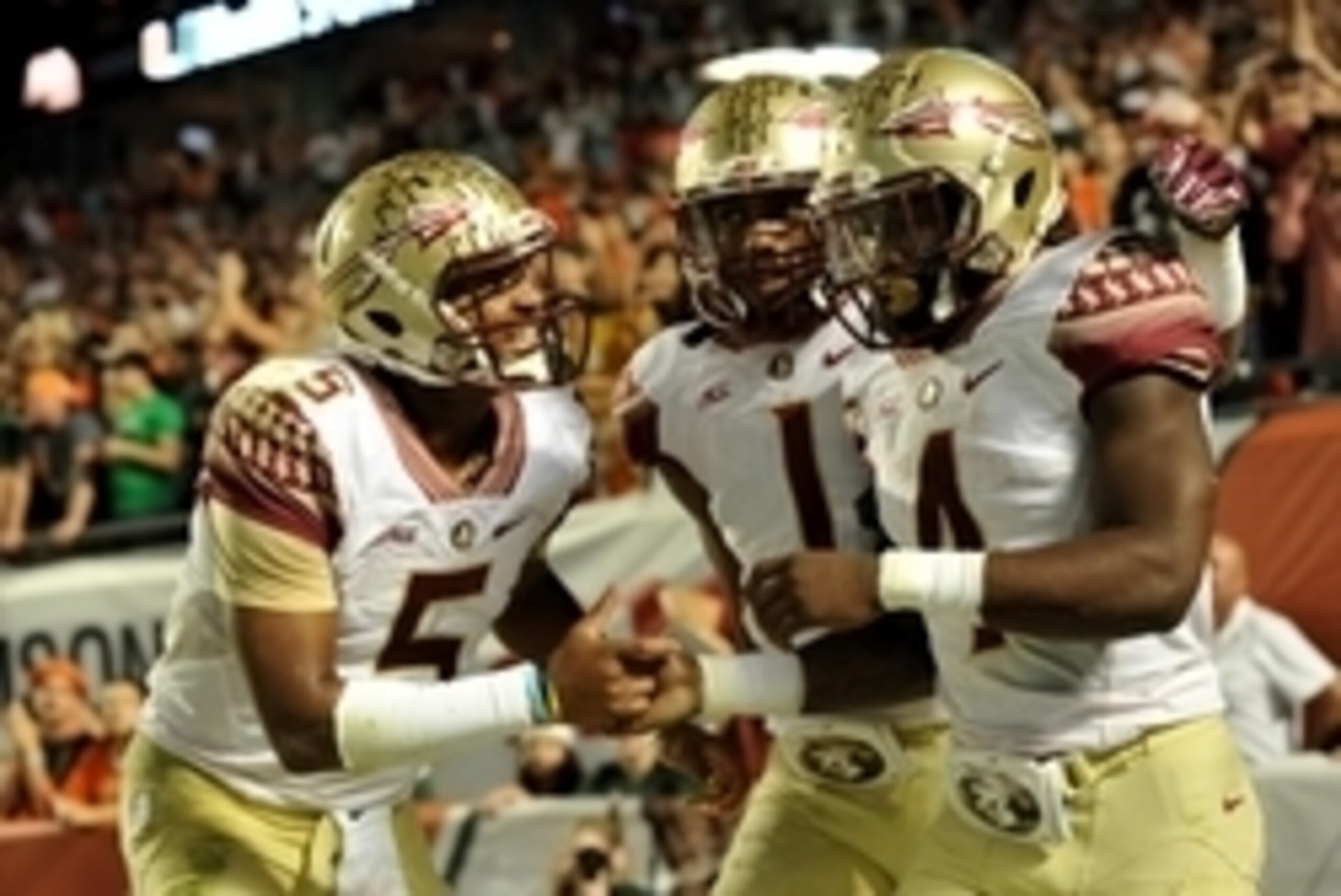Nov 15, 2014; Miami Gardens, FL, USA; Florida State Seminoles quarterback Jameis Winston (left) greets running back Dalvin Cook (right) after scoring a touchdown during the second half against Miami Hurricanes at Sun Life Stadium. Mandatory Credit: Steve 