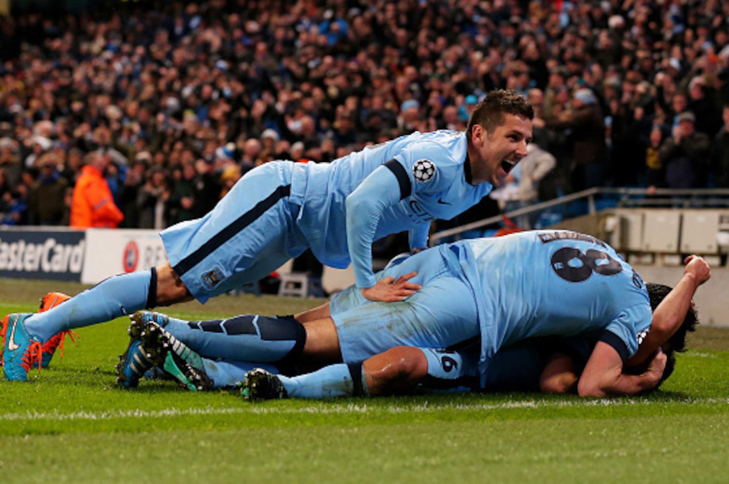 MANCHESTER, ENGLAND - NOVEMBER 25: Sergio Aguero #16 (on ground) of Manchester City celebrates with teammate Stevan Jovetic (L) and Frank Lampard #18 after scoring his team's third and matchwinning goal during the UEFA Champions League Group E match betw MANCHESTER, ENGLAND - NOVEMBER 25: Sergio Aguero #16 (on ground) of Manchester City celebrates with teammate Stevan Jovetic (L) and Frank Lampard #18 after scoring his team's third and matchwinning goal during the UEFA Champions League Group E match betw