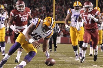 LSU quarterback Anthony Jennings (No. 10) chases after a botched snap against Arkansas.