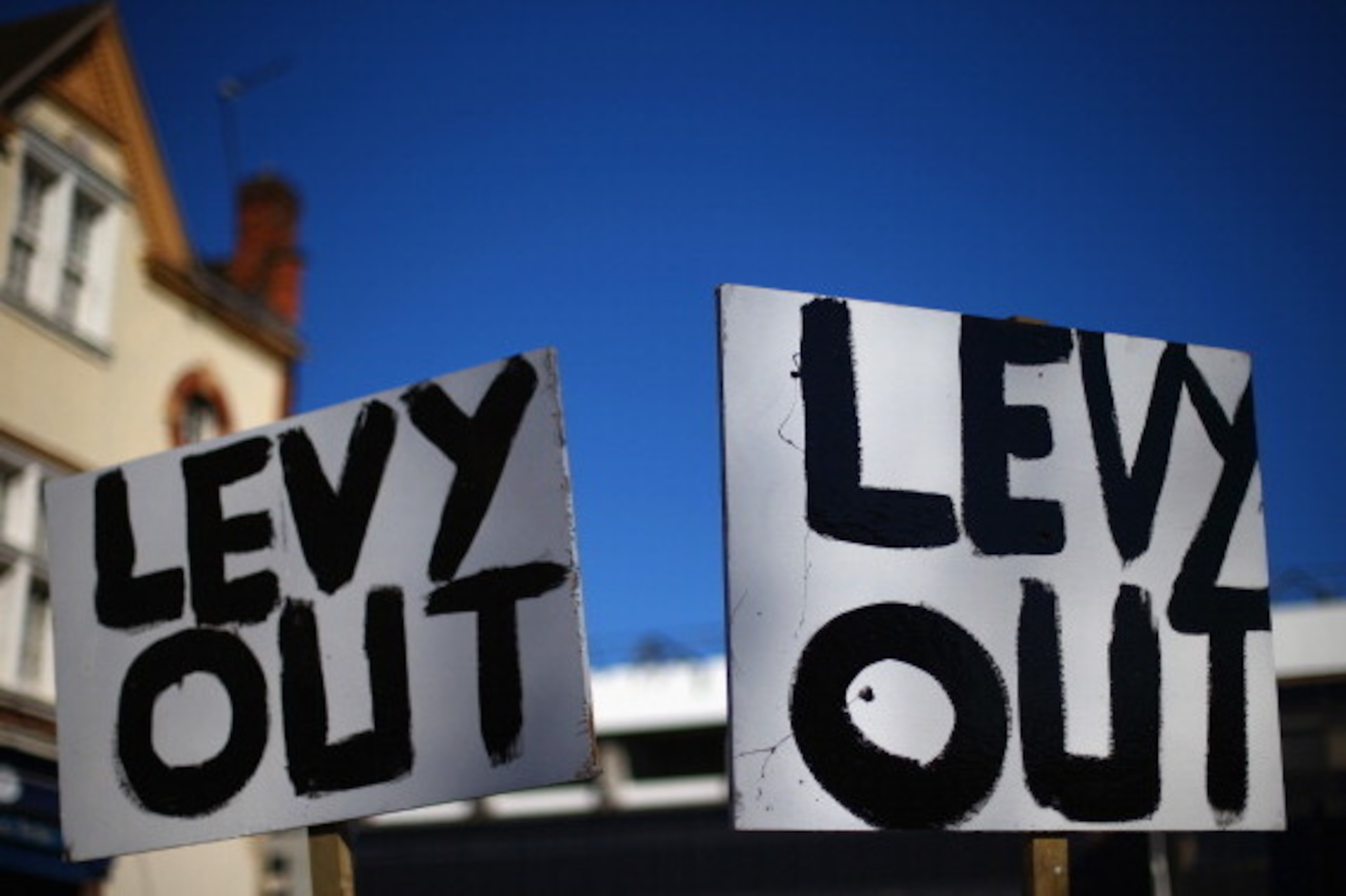 LONDON, ENGLAND - MARCH 16:  A sign saying 'Levy Out' is seen in protest of Daniel Levy, Tottenham Hotspur Chairman ahead of the Barclays Premier League match between Tottenham Hotspur and Arsenal at White Hart Lane on March 16, 2014 in London, England.