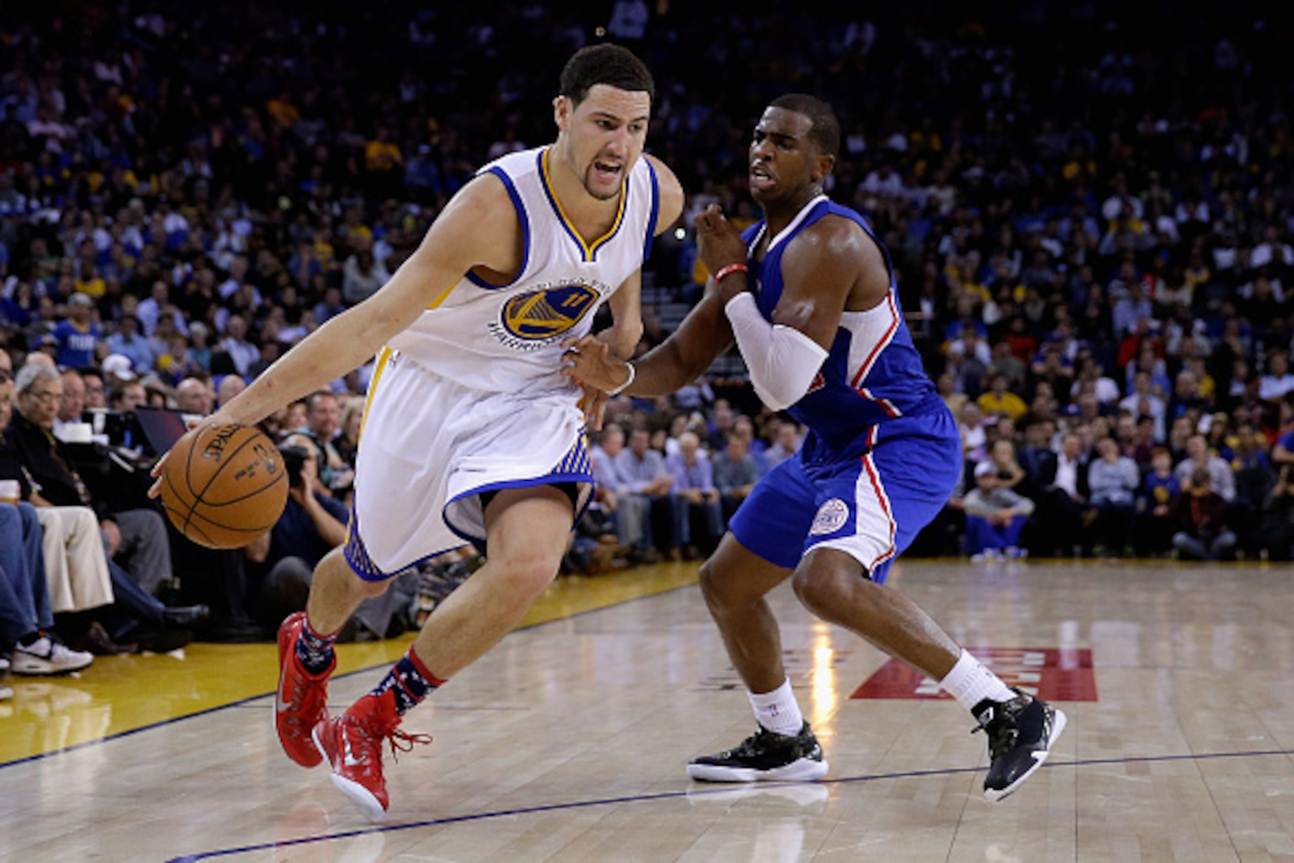 OAKLAND, CA - NOVEMBER 05:  Klay Thompson #11 of the Golden State Warriors drives on Chris Paul #3 of the Los Angeles Clippers at ORACLE Arena on November 5, 2014 in Oakland, California. NOTE TO USER: User expressly acknowledges and agrees that, by downlo