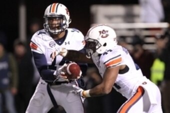 Nov 1, 2014; Oxford, MS, USA; Auburn Tigers quarterback Nick Marshall (14) hands off to running back Cameron Artis-Payne (44) during the game against the Ole Miss Rebels at Vaught-Hemingway Stadium. Auburn defeated Ole Miss 35-31. Mandatory Credit: Nelson