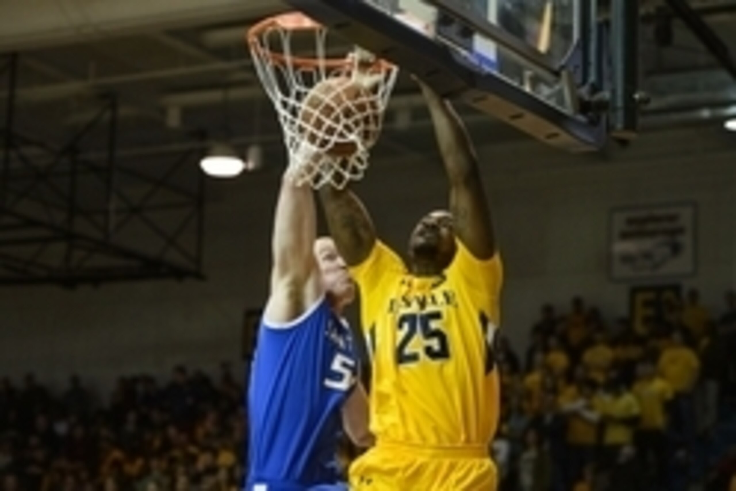 Feb 8, 2014; Philadelphia, PA, USA; La Salle Explorers forward Jerrell Wright (25) dunks as Saint Louis Billikens center John Manning (54) defends during the first half at Tom Gola Arena. Mandatory Credit: Howard Smith-USA TODAY Sports