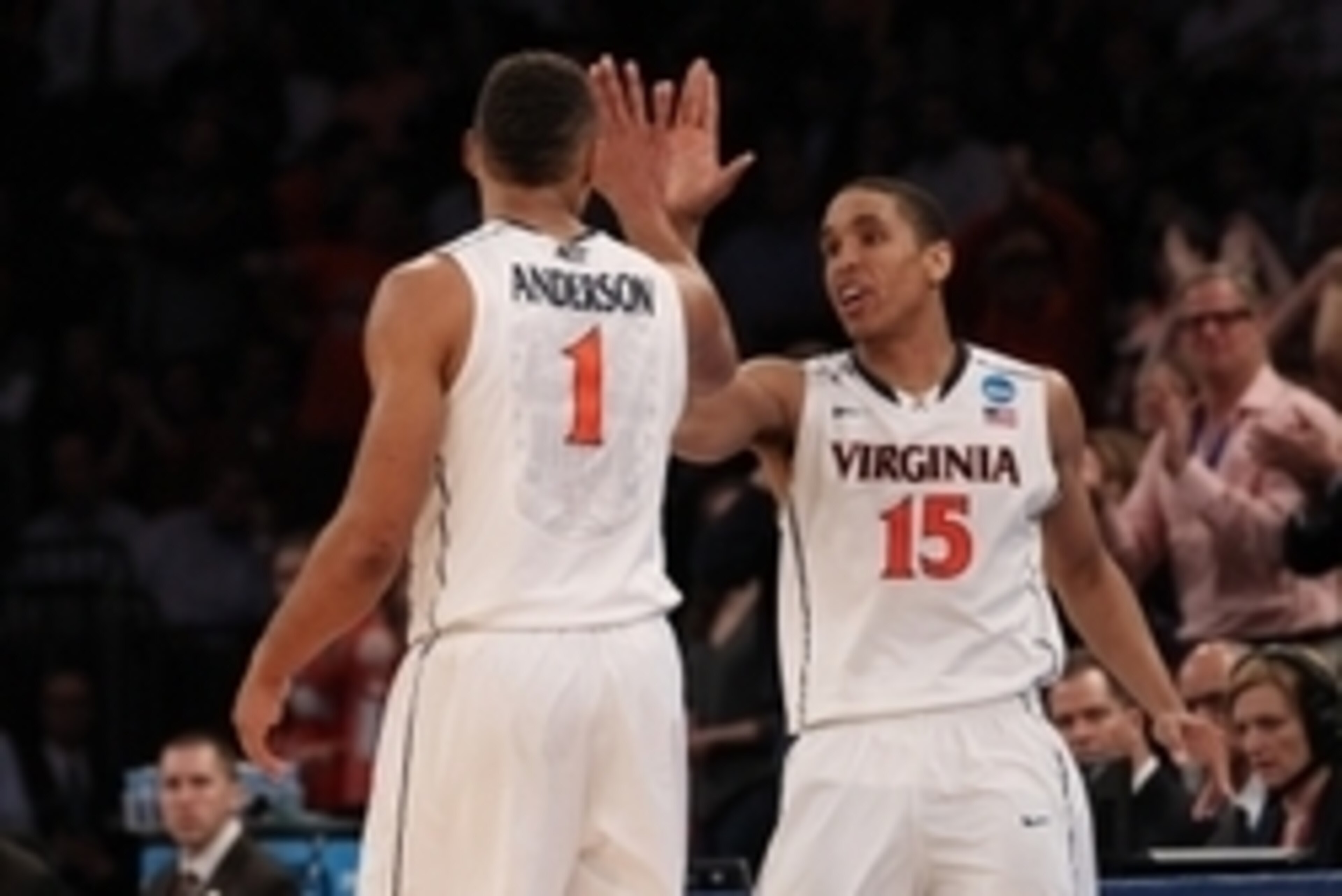 Mar 28, 2014; New York, NY, USA; Virginia Cavaliers guard Malcolm Brogdon (15) celebrates with Virginia Cavaliers guard Justin Anderson (1) during the second half in the semifinals of the east regional of the 2014 NCAA Mens Basketball Championship tournam