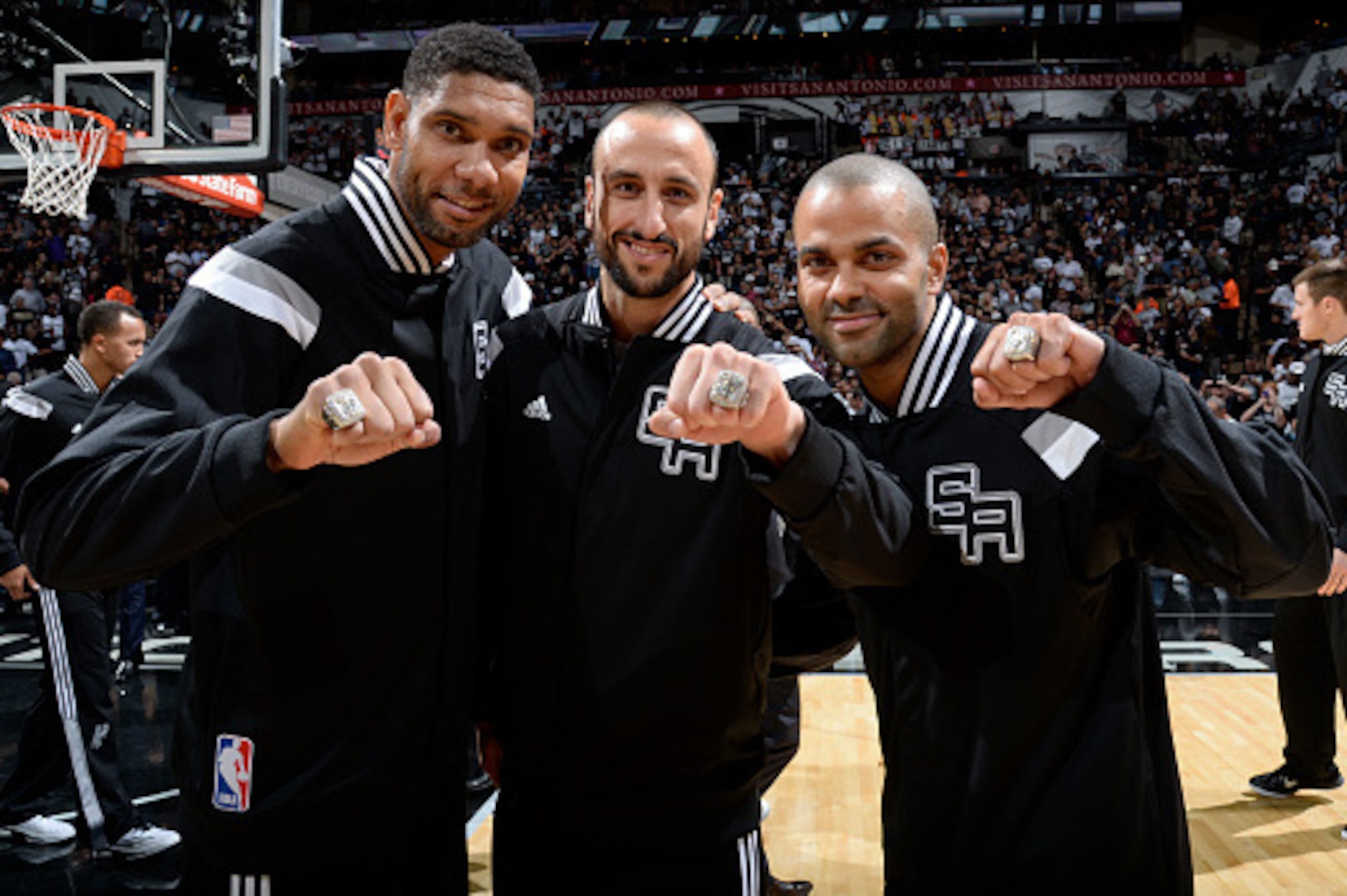 SAN ANTONIO, TX - OCTOBER 28:   Tim Duncan #21 Manu Ginobili #20 and Tony Parker #9 of the San Antonio Spurs receive Championship Rings prior to the game against the Dallas Mavericks at the AT&T Center on October 28, 2014 in San Antonio, Texas. NOTE TO US