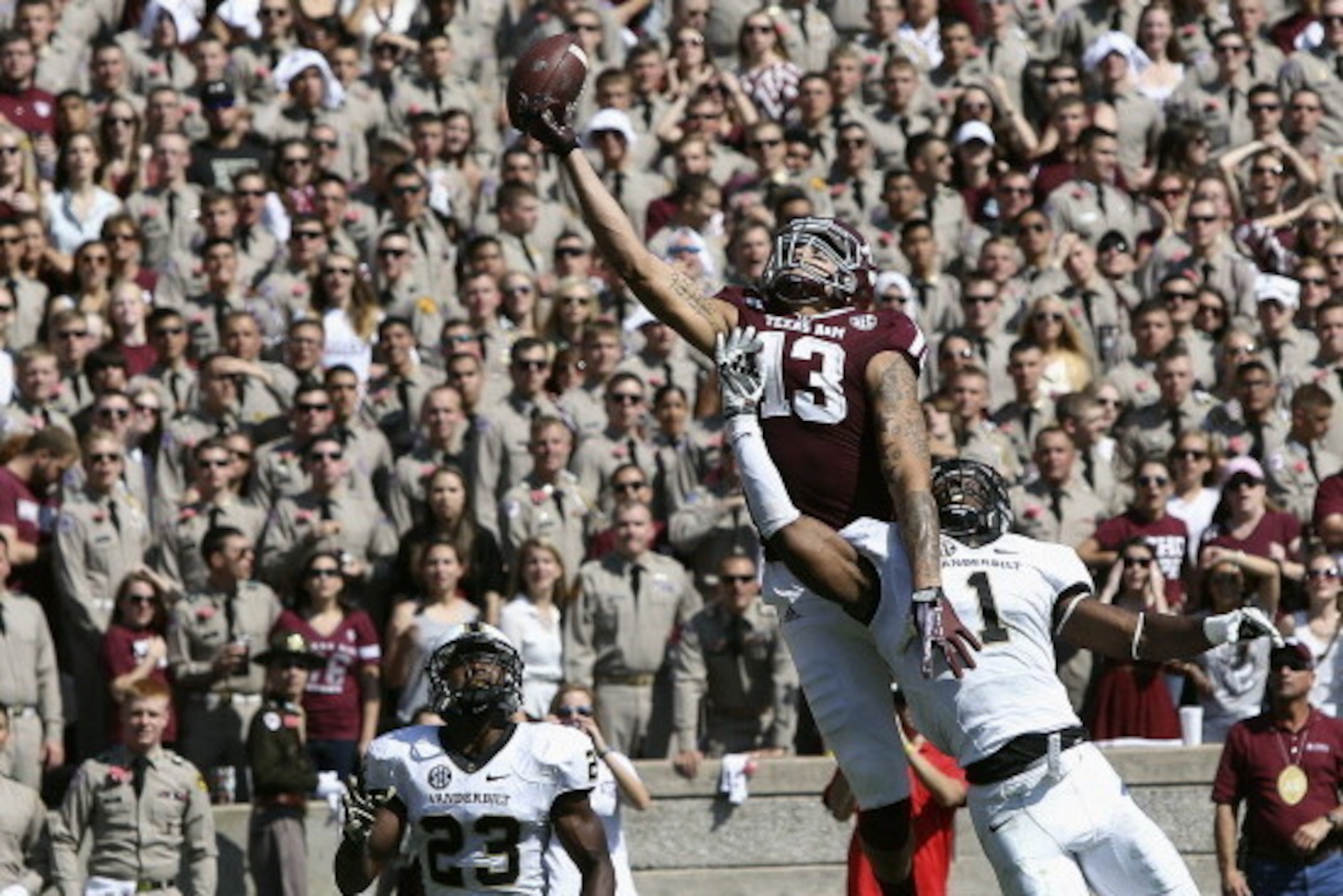 COLLEGE STATION, TX - OCTOBER 26: Mike Evans #13 of the Texas A&M Aggies has the ball go off his fingertips as he goes up between Kenny Ladler #1 of the Vanderbilt Commodores and Andre Hal #23 of the Vanderbilt Commodores in the second quarter at Kyle Fi COLLEGE STATION, TX - OCTOBER 26: Mike Evans #13 of the Texas A&M Aggies has the ball go off his fingertips as he goes up between Kenny Ladler #1 of the Vanderbilt Commodores and Andre Hal #23 of the Vanderbilt Commodores in the second quarter at Kyle Fi