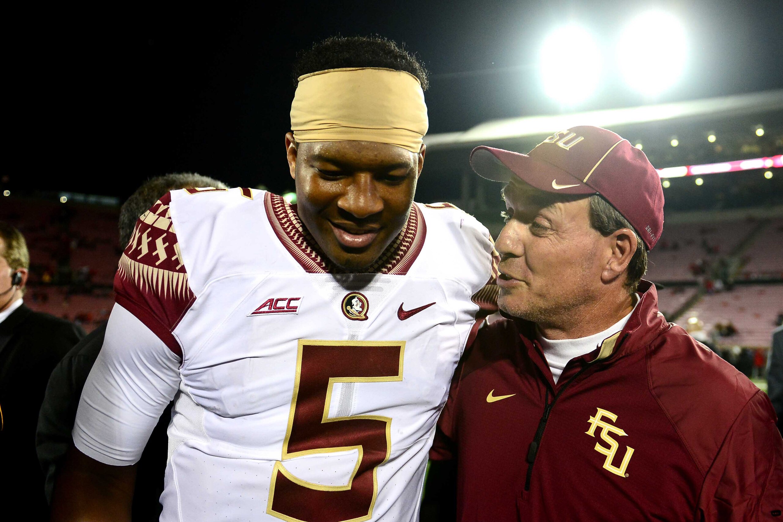 Oct 30, 2014; Louisville, KY, USA;  Florida State Seminoles quarterback Jameis Winston (5) and head coach Jimbo Fisher walk off the field after defeating the Louisville Cardinals 42-31 at Papa John's Cardinal Stadium. Mandatory Credit: Andrew Weber-USA TO