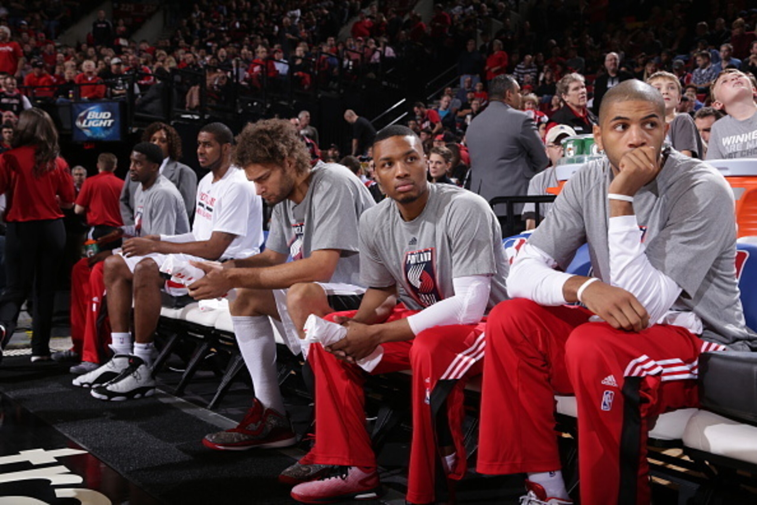 PORTLAND, OR - NOVEMBER 6:  (L-R) Robin Lopez #42, Damian Lillard #0, and Nicolas Batum #88 of the Portland Trail Blazers on the bench before the game against the Dallas Mavericks on November 6, 2014 at the Moda Center Arena in Portland, Oregon. NOTE TO U