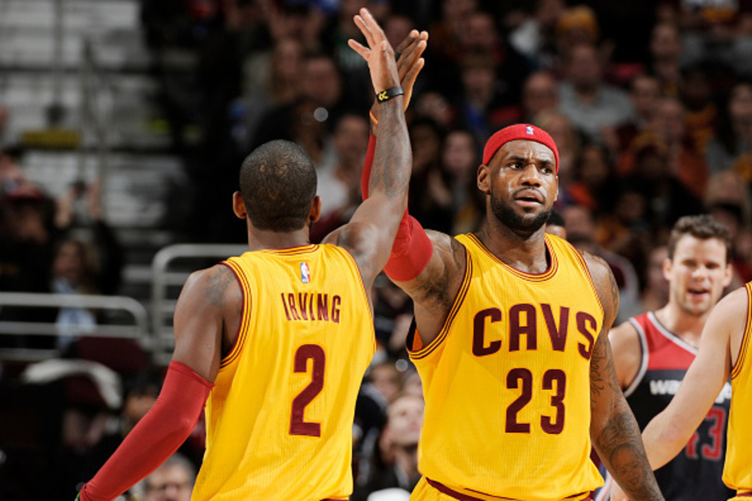 CLEVELAND, OH -  NOVEMBER 26: LeBron James #23 high fives teammate Kyrie Irving #2 of the Cleveland Cavaliers during the game against the Washington Wizards on November 26, 2014 at Quicken Loans Arena in Cleveland, Ohio. NOTE TO USER: User expressly ackno