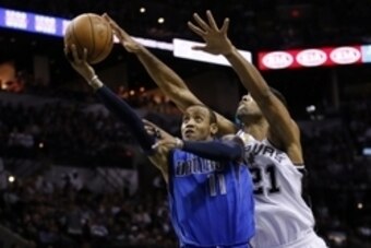 Oct 28, 2014; San Antonio, TX, USA; Dallas Mavericks shooting guard Monta Ellis (11) drives to the basket under pressure from San Antonio Spurs power forward Tim Duncan (21) during the second half at AT&T Center. The Spurs won 101-100. Mandatory Credit: S