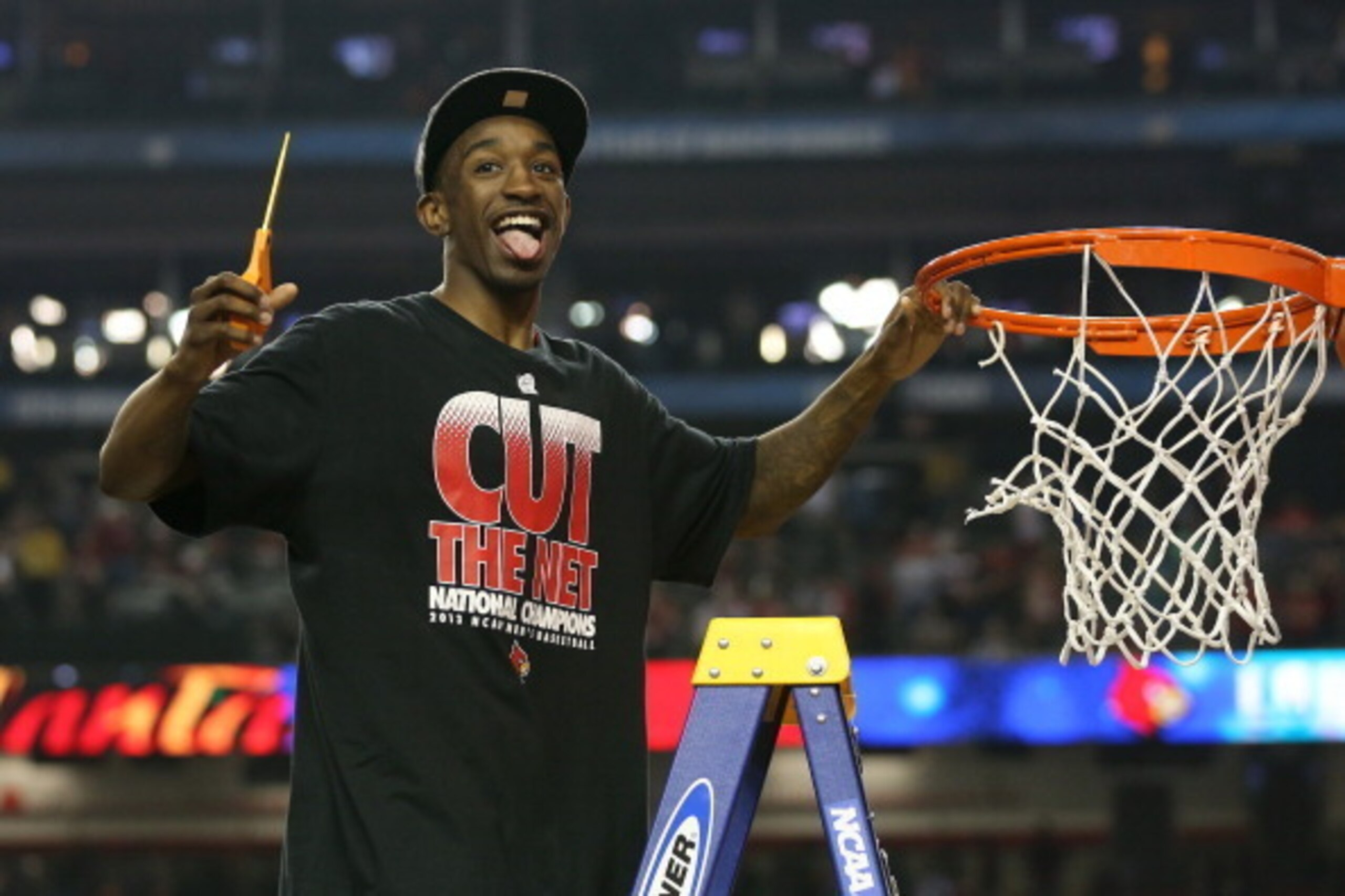 ATLANTA, GA - APRIL 08:  Russ Smith #2 of the Louisville Cardinals celebrates as he cuts down the net after they won 82-76 against the Michigan Wolverines during the 2013 NCAA Men's Final Four Championship at the Georgia Dome on April 8, 2013 in Atlanta, 