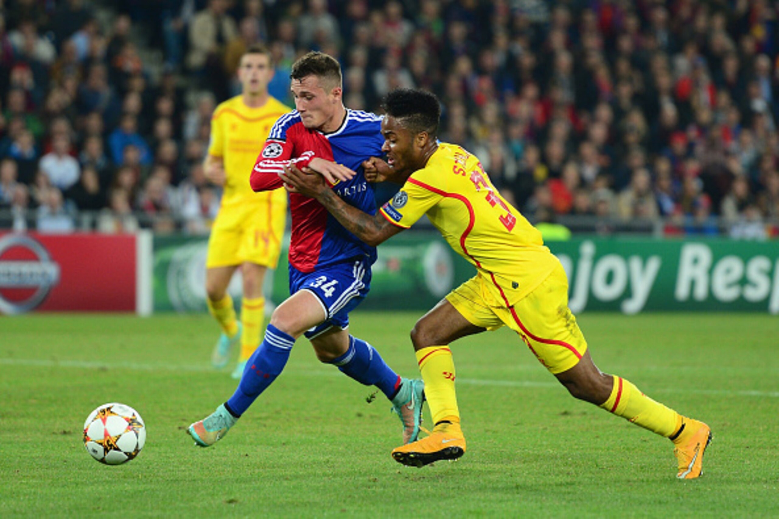 BASEL, SWITZERLAND - OCTOBER 01:  Taulant Xhaka of FC Basel and Raheem Sterling of Liverpool battle for the ball during the UEFA Champions League Group B match between FC Basel 1893 and Liverpool FC at St. Jakob Stadium on October 1, 2014 in Basel, Switze