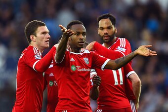 LEICESTER, ENGLAND - NOVEMBER 01:  Saido Berahino of West Brom celebrates with team mates after Esteban Cambiasso of Leicester City scored an own goal during the Barclays Premier League match between Leicester City and West Bromwich Albion at The King Pow