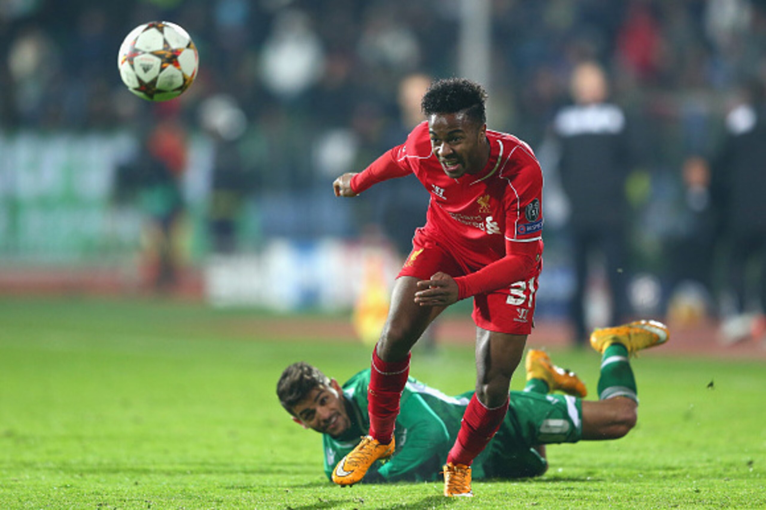 SOFIA, BULGARIA - NOVEMBER 26:  Raheem Sterling of Liverpool (R)  escapes the attentions of Junior Caicaara of Ludogorets during the UEFA Champions League Group B match between Ludogorets Razgrad and Liverpool at the Vasil Levski Stadium on November 26, 2