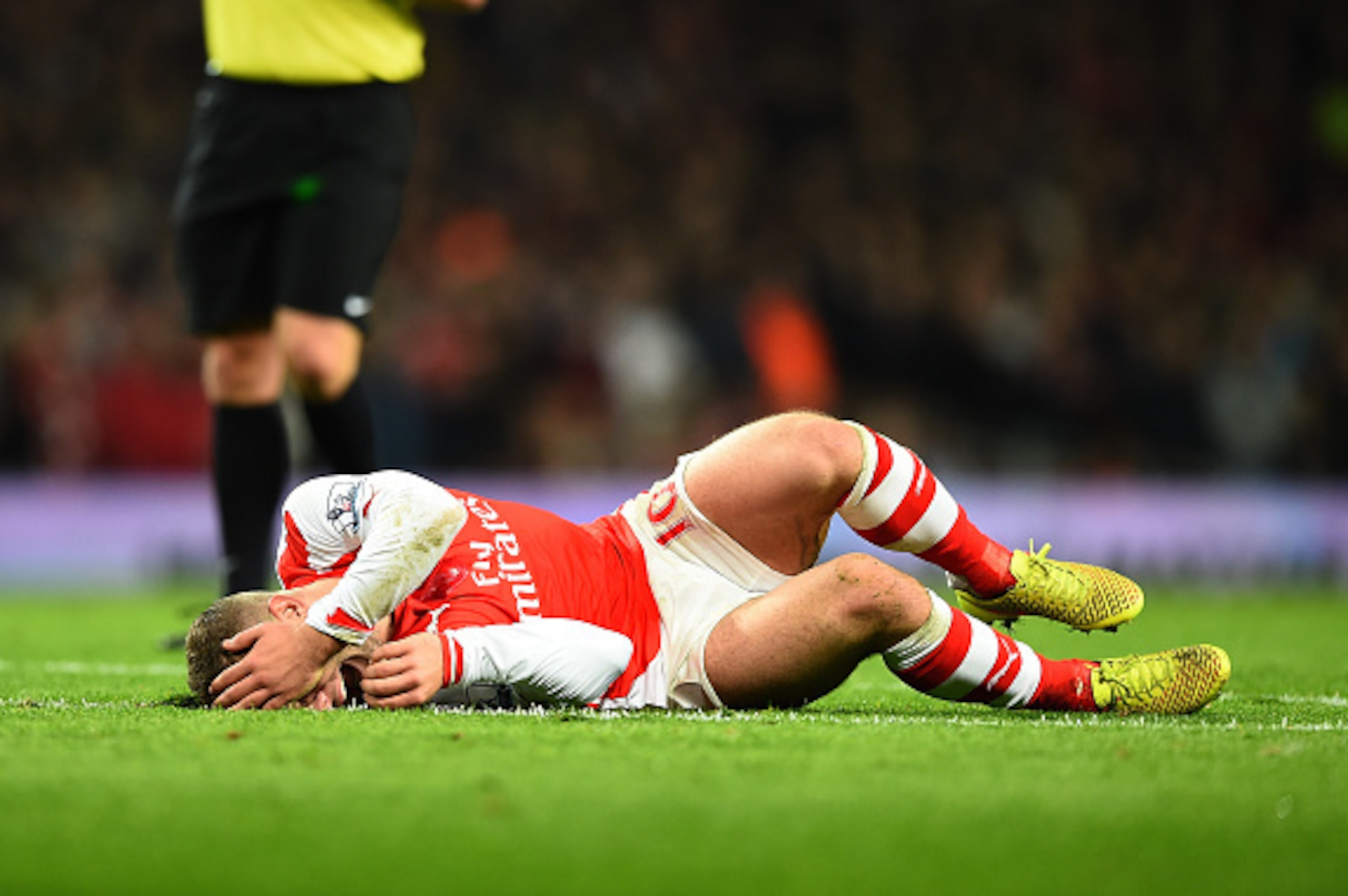 LONDON, ENGLAND - NOVEMBER 22:  Jack Wilshere of Arsenal lies injured after a tackle during the Barclays Premier League match between Arsenal and Manchester United at Emirates Stadium on November 22, 2014 in London, England. (Photo by Shaun Botterill/Gett