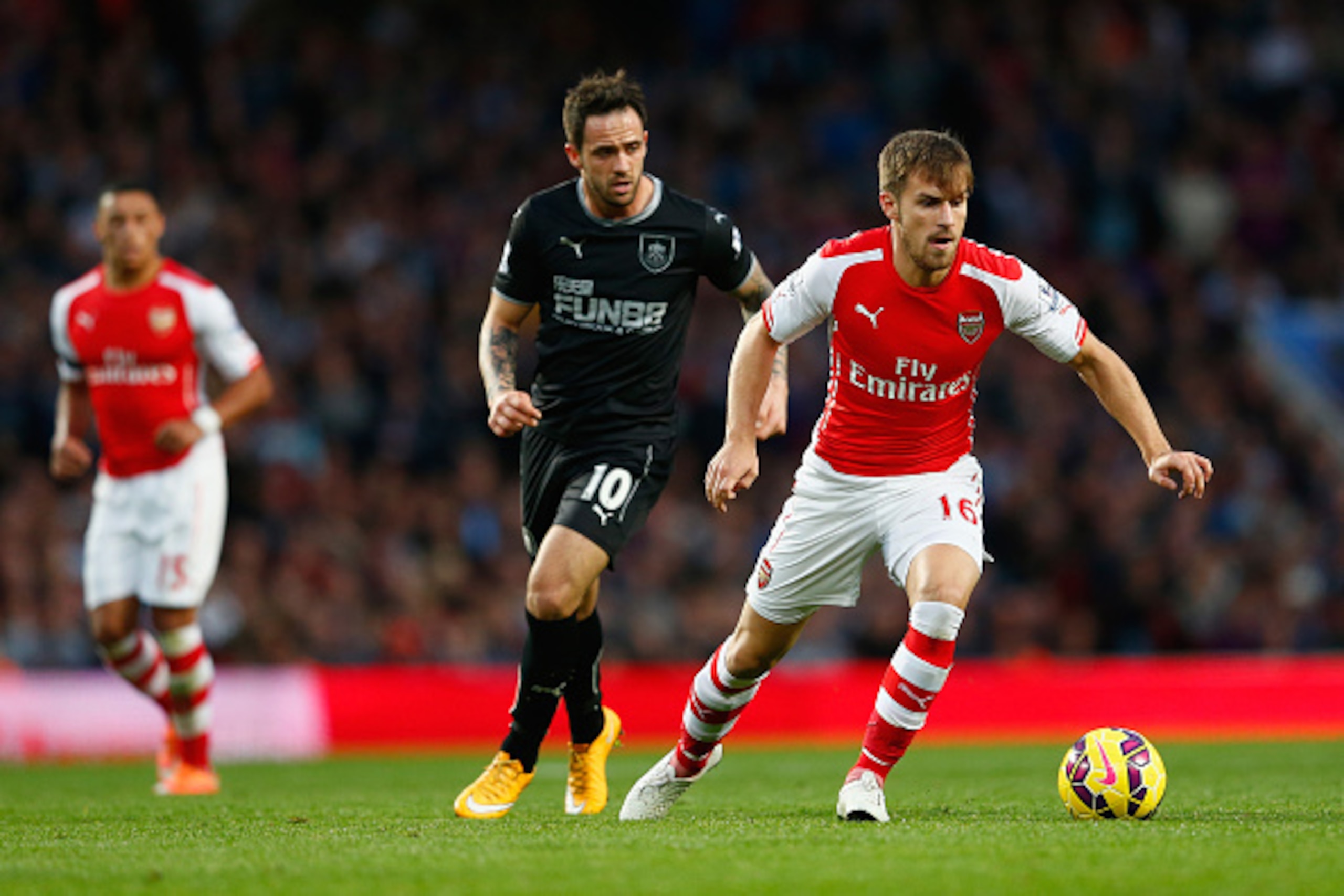 LONDON, ENGLAND - NOVEMBER 01:  Danny Ings of Burnley and Aaron Ramsey of Arsenal (R) in action during the Barclays Premier League match between Arsenal and Burnley at Emirates Stadium on November 1, 2014 in London, England.  (Photo by Julian Finney/Getty