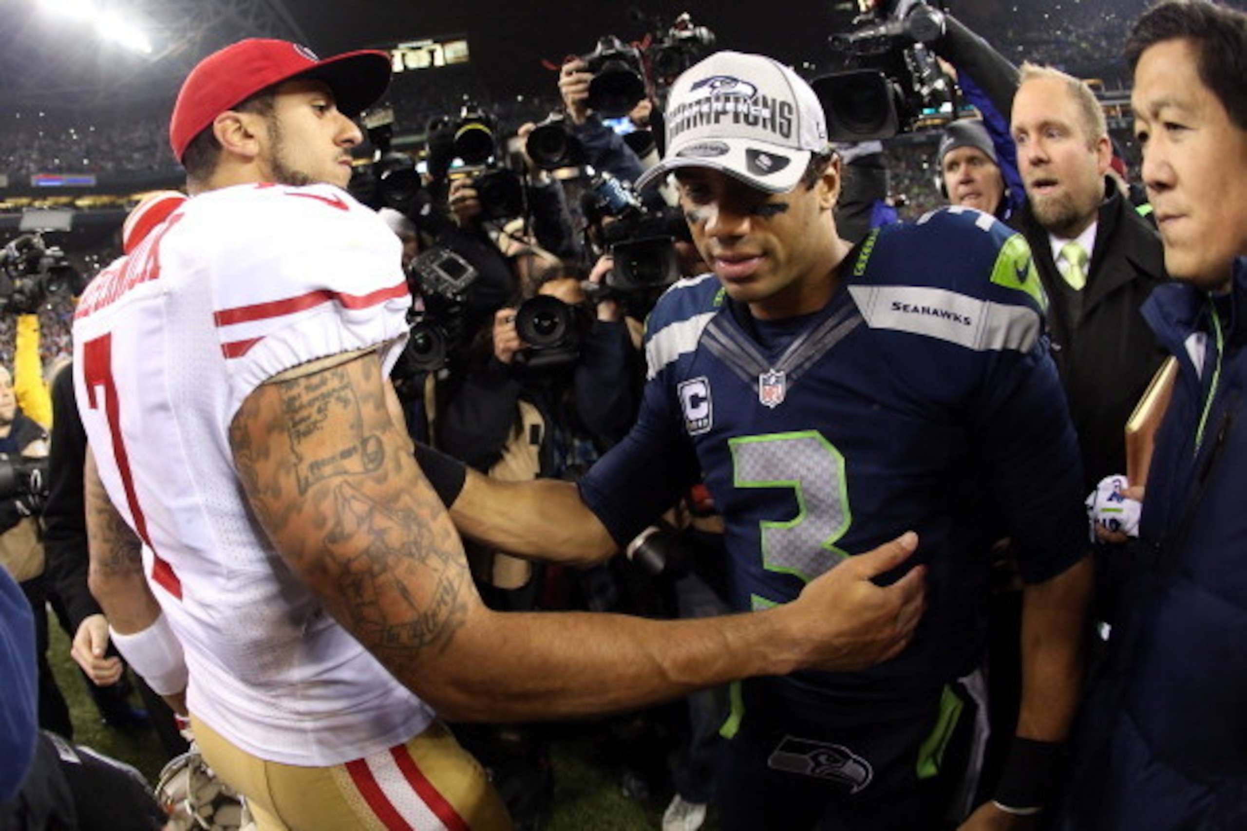 SEATTLE, WA - JANUARY 19:  Quarterback Colin Kaepernick #7 of the San Francisco 49ers shakes hands with quarterback Russell Wilson #3 of the Seattle Seahawks after the Seahawks defeated the 49ers 23-17 during the 2014 NFC Championship at CenturyLink Field