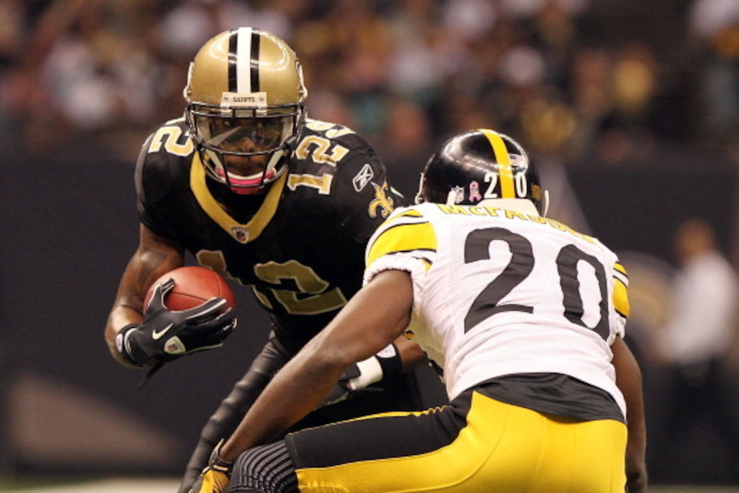 NEW ORLEANS - OCTOBER 31: Marques Colston #12 of the New Orleans Saints is tackled by Bryant McFadden #20 of the Pittsburgh Steelers at the Louisiana Superdome on October 31, 2010 in New Orleans, Louisiana. (Photo by Matthew Sharpe/Getty Images)