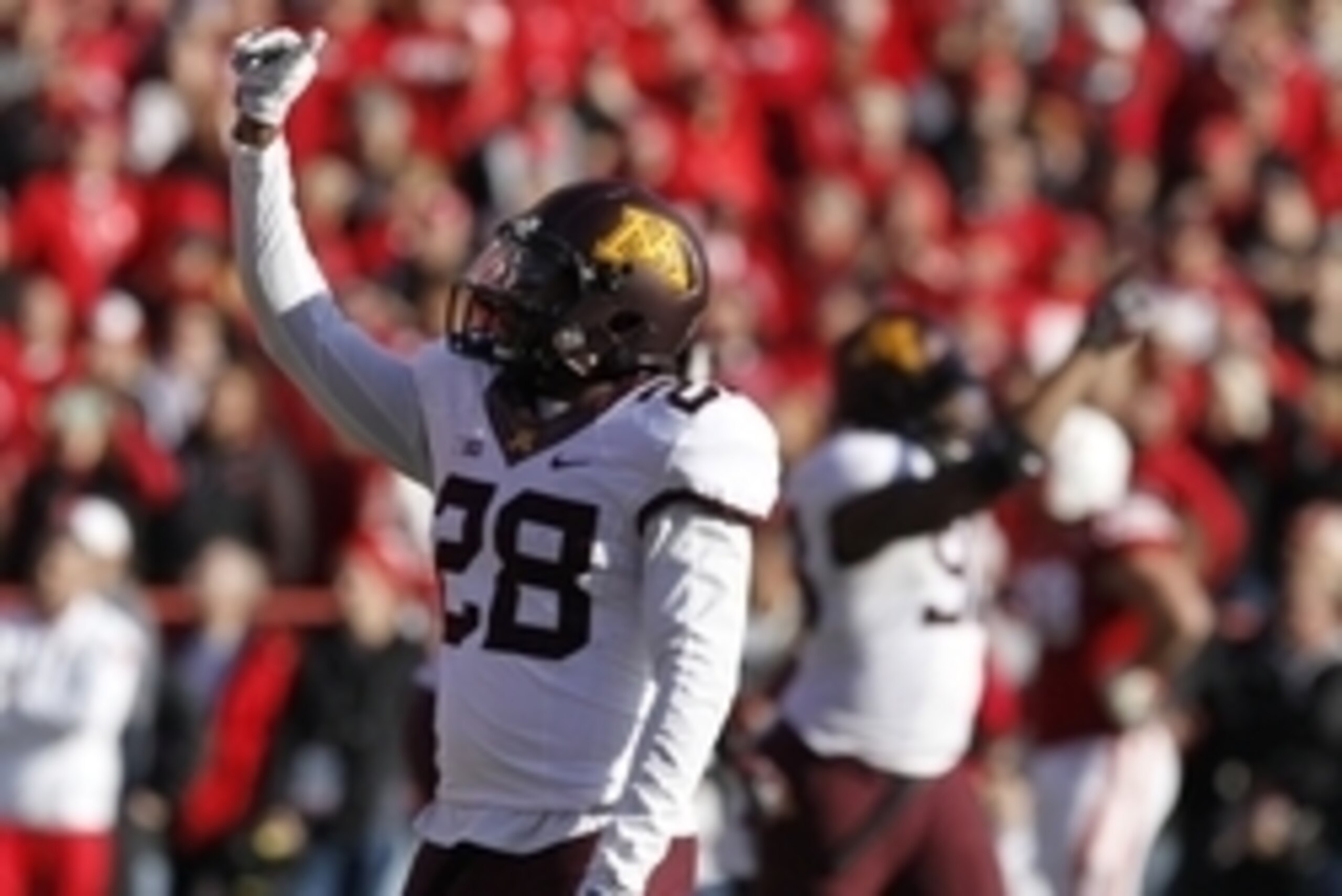 Nov 22, 2014; Lincoln, NE, USA; Minnesota Golden Gophers defender Jalen Myrick (28) waves to the crowd after defender Briean Boddy-Calhoun (not pictured) recovered a fumble against the Nebraska Cornhuskers in the final moments of the second half at Memori