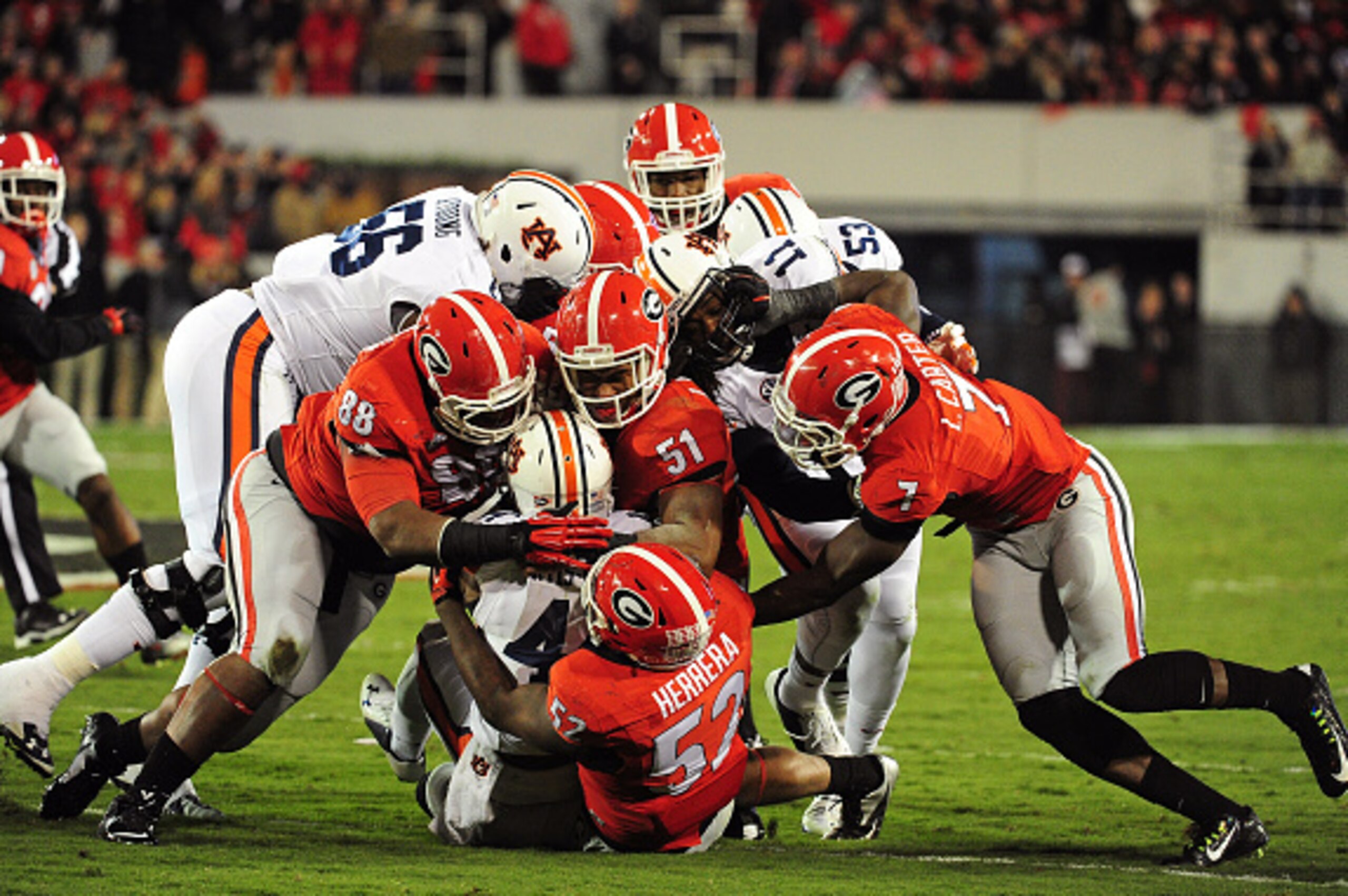 ATHENS, GA - NOVEMBER 15: Nick Marshall #14 of the Auburn Tigers is tackled by Amarlo Herrera #52 and Ramik Wilson #51 of the Georgia Bulldogs at Sanford Stadium on November 15, 2014 in Athens, Georgia. (Photo by Scott Cunningham/Getty Images) ATHENS, GA - NOVEMBER 15: Nick Marshall #14 of the Auburn Tigers is tackled by Amarlo Herrera #52 and Ramik Wilson #51 of the Georgia Bulldogs at Sanford Stadium on November 15, 2014 in Athens, Georgia. (Photo by Scott Cunningham/Getty Images)