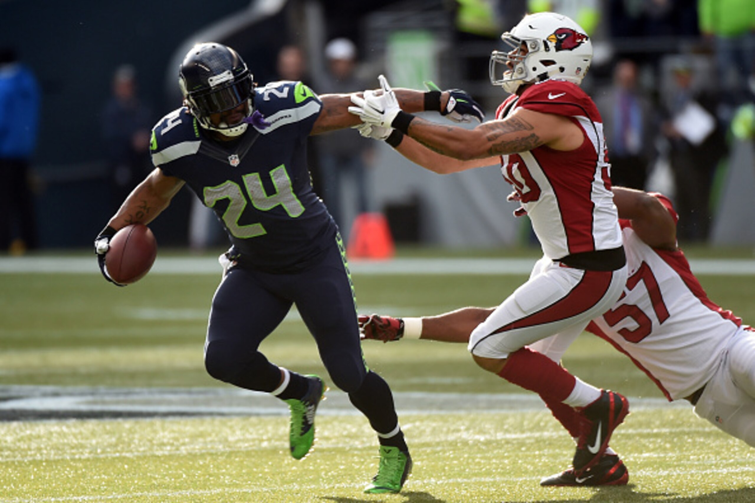 SEATTLE, WA - NOVEMBER 23:  Marshawn Lynch #24 of the Seattle Seahawks runs the ball in the first quarter against Larry Foote #50 of the Arizona Cardinals during their game at CenturyLink Field on November 23, 2014 in Seattle, Washington.  (Photo by Steve