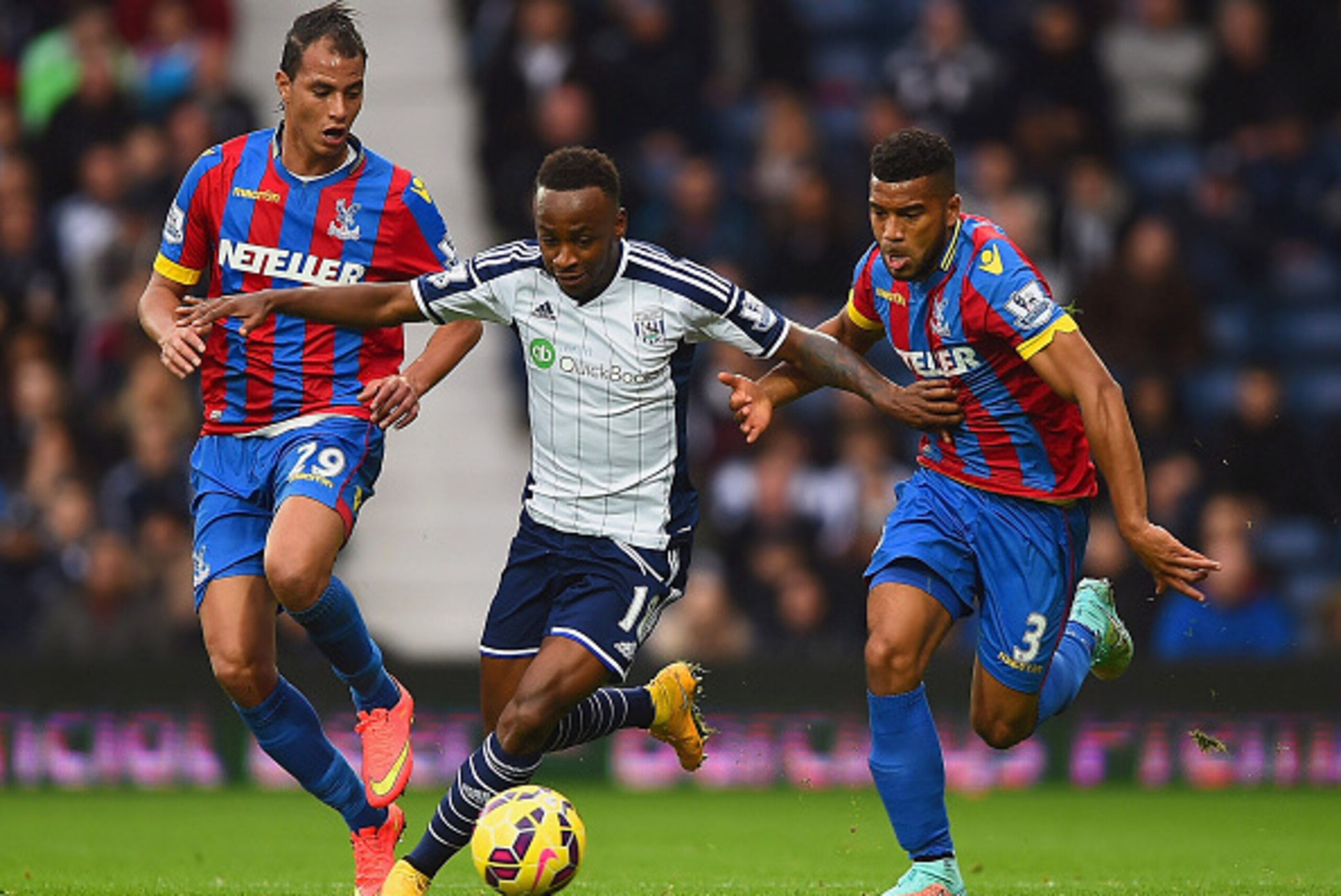 WEST BROMWICH, ENGLAND - OCTOBER 25: Saido Berahino of West Brom is closed down by Marouane Chamakh (L) and Adrian Mariappa of Crystal Palace during the Barclays Premier League match between West Bromwich Albion and Crystal Palace at The Hawthorns on Octo