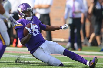 MINNEAPOLIS, MN - SEPTEMBER 28:  Teddy Bridgewater #5 of the Minnesota Vikings slides with the ball for a gain against the Atlanta Falcons on September 28, 2014 at TCF Bank Stadium in Minneapolis, Minnesota. (Photo by Adam Bettcher/Getty Images)