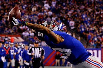 EAST RUTHERFORD, NJ - NOVEMBER 23:  Odell Beckham #13 of the New York Giants scores a touchdown in the second quarter against the Dallas Cowboys at MetLife Stadium on November 23, 2014 in East Rutherford, New Jersey.  (Photo by Al Bello/Getty Images)