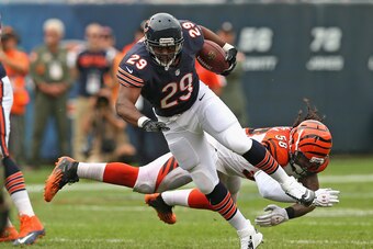 CHICAGO, IL - SEPTEMBER 08:  Michael Bush #29 of the Chicago Bears breaks a tackle attempt by Rey Maualuga #58 of the Cincinnati Bengals at Soldier Field on September 8, 2013 in Chicago, Illinois. The Bears defeated the Bengals 24-21.  (Photo by Jonathan