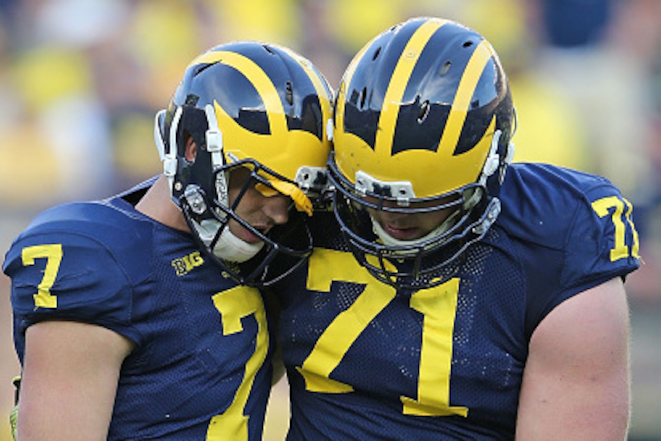 ANN ARBOR, MI - SEPTEMBER 27: Quarterback Shane Morris #7 of the Michigan Wolverines is helped off the field by Ben Braden #71 during the fourth quarter of the game against the Minnesota Golden Gophers at Michigan Stadium on September 27, 2014 in Ann Arbo