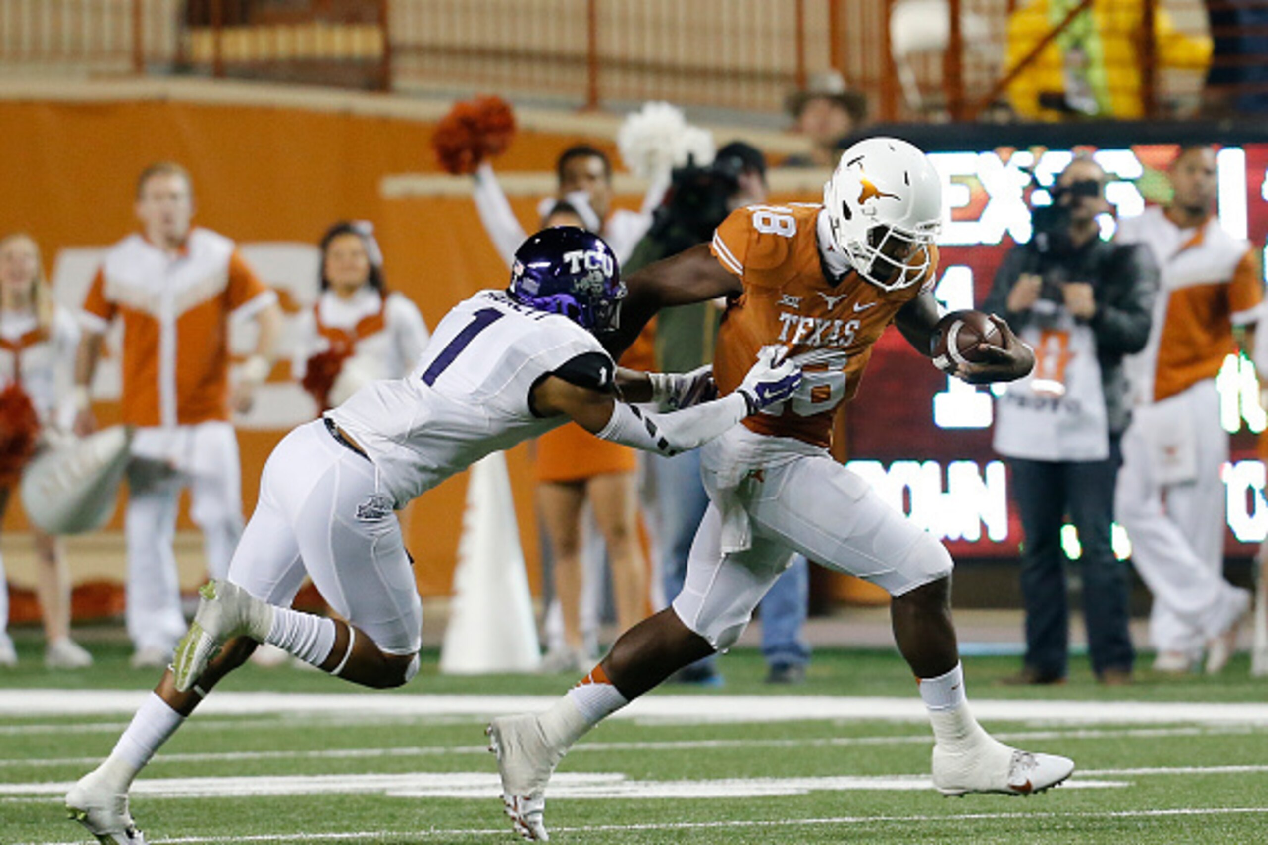 AUSTIN, TX - NOVEMBER 27: Chris Hackett #1 of the TCU Horned Frogs grabs the jersey of Tyrone Swoopes #18 of the Texas Longhorns at the Darrell K Royal -Texas Memorial Stadium on November 27, 2014 in Austin. Texas. (Photo by Chris Covatta/Getty Images)