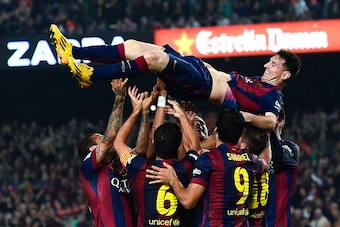 BARCELONA, SPAIN - NOVEMBER 22:  Lionel Messi of FC Barcelona celebrates with his teammates after scoring his team's fourth goal during the La Liga match between FC Barcelona and Sevilla FC at Camp Nou on November 22, 2014 in Barcelona, Spain. Lionel Mess