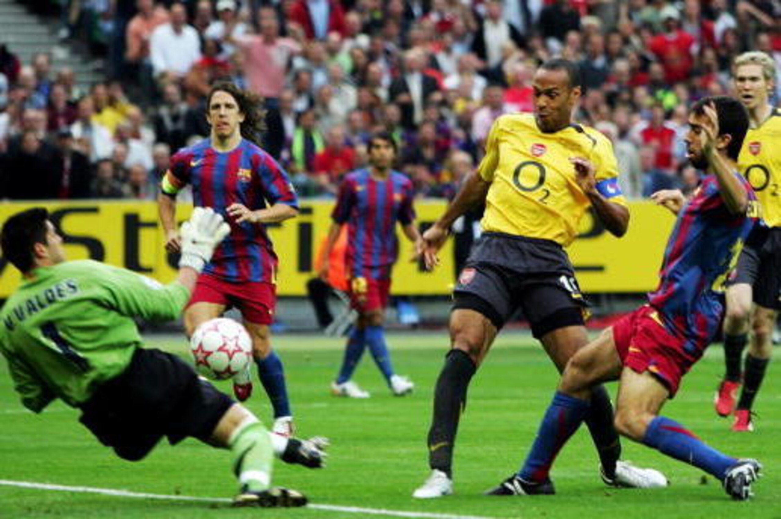 PARIS - MAY 17: (L-R) Victor Valdes the Barcelona goalkeeper saves from Thierry Henry of Arsenal during the UEFA Champions League Final between Arsenal and Barcelona at the Stade de France on May 17, 2006 in Paris, France. (Photo by Mike Hewitt/Getty Im PARIS - MAY 17: (L-R) Victor Valdes the Barcelona goalkeeper saves from Thierry Henry of Arsenal during the UEFA Champions League Final between Arsenal and Barcelona at the Stade de France on May 17, 2006 in Paris, France. (Photo by Mike Hewitt/Getty Im