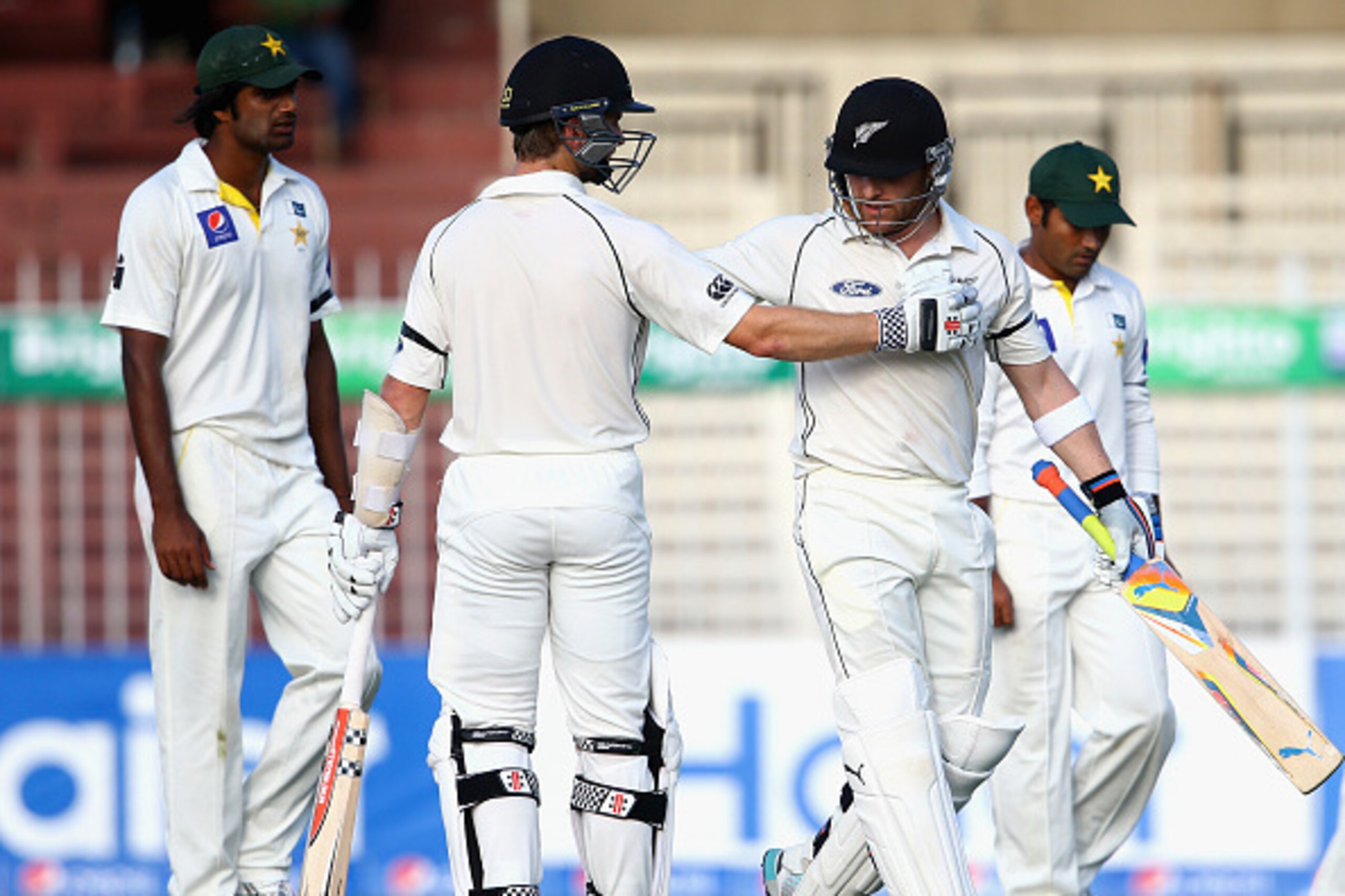 SHARJAH, UNITED ARAB EMIRATES - NOVEMBER 28:  Kane Williamson congratulates Brendon McCullum on reaching his century during day two of the third test between Pakistan and New Zealand at Sharjah Stadium on November 28, 2014 in Sharjah, United Arab Emirates