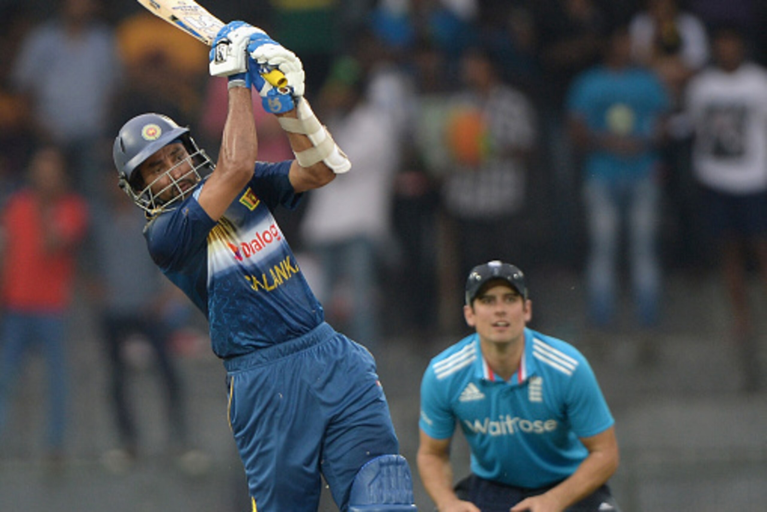 COLOMBO, SRI LANKA - NOVEMBER 26:  Tillakaratne Dilshan of Sri Lanka bats watched by England captain Alastair Cook during the 1st One Day International between Sri Lanka and England at R. Premadasa Stadium on November 26, 2014 in Colombo, Sri Lanka.  (Pho