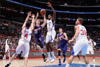 LOS ANGELES, LA -  NOVEMBER 15: Goran Dragic #1 of the Phoenix Suns goes for a lay up against J.J. Redick #4 and DeAndre Jordan #6 of the Los Angeles Clippers during the game on November 15, 2014 at STAPLES CENTER in Los Angeles, California. NOTE TO USER: