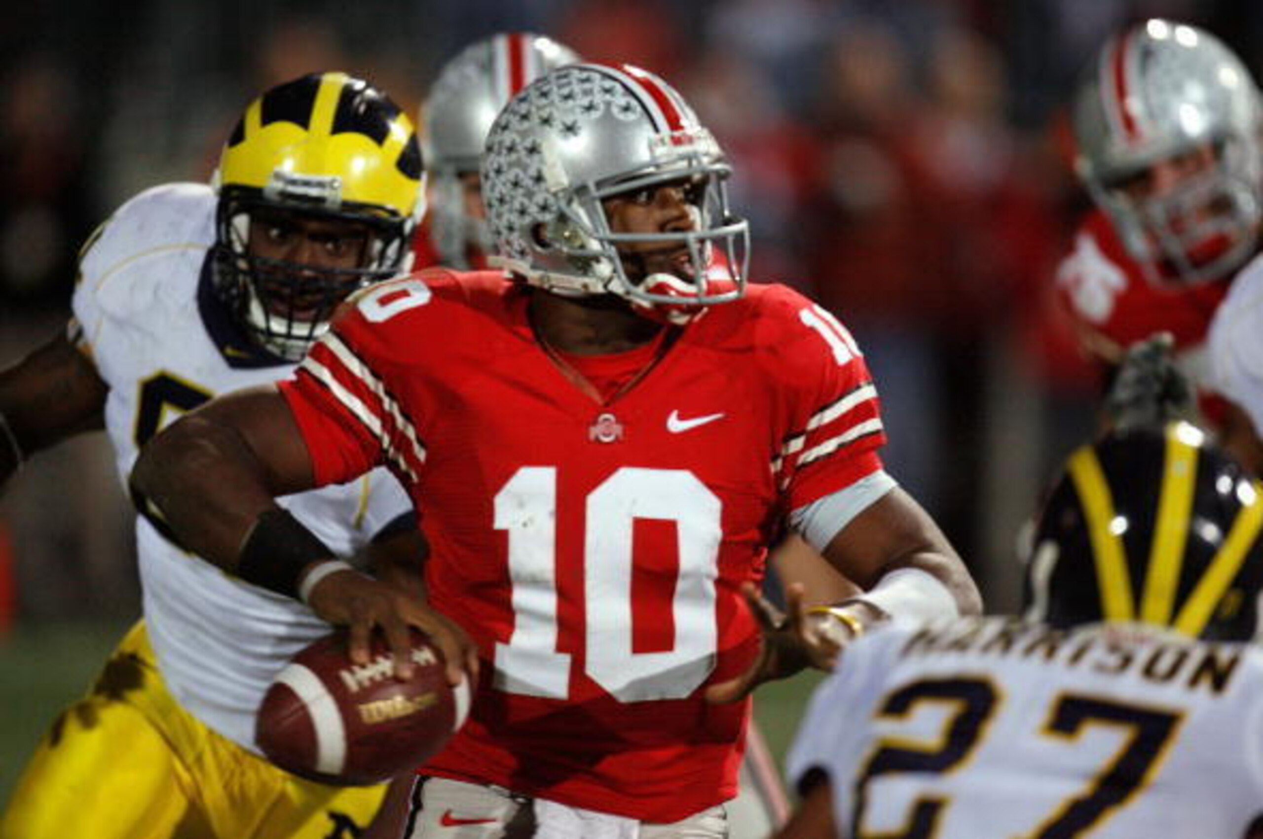 COLUMBUS, OH - NOVEMBER 18:  Quarterback Troy Smith #10 of the Ohio State Buckeyes throws a 3 quarter interception under pressure from the Michigan Wolverines defense November 18, 2006 at Ohio Stadium in Columbus, Ohio.  (Photo by Gregory Shamus/Getty Ima