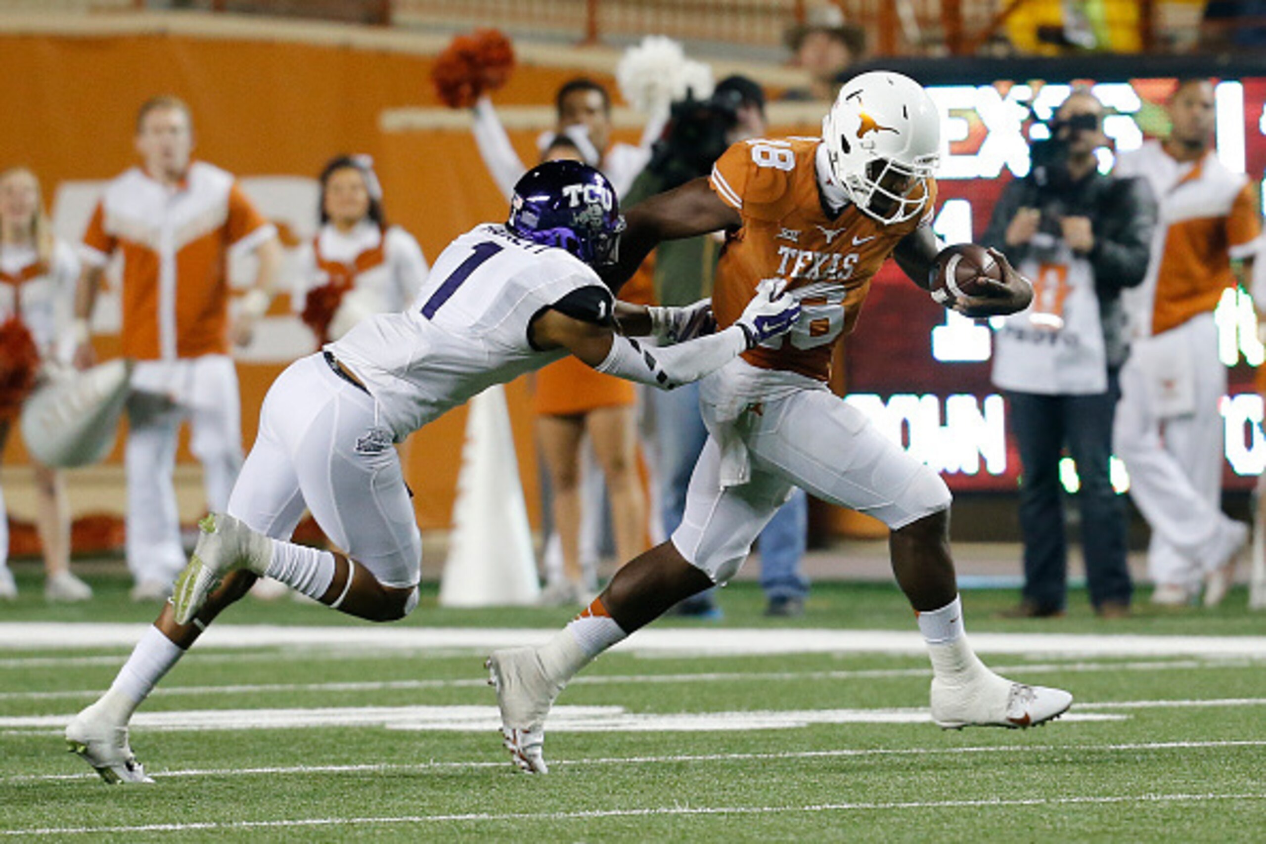 AUSTIN, TX - NOVEMBER 27: Chris Hackett #1 of the TCU Horned Frogs grabs the jersey of Tyrone Swoopes #18 of the Texas Longhorns at the Darrell K Royal -Texas Memorial Stadium on November 27, 2014 in Austin. Texas. (Photo by Chris Covatta/Getty Images)