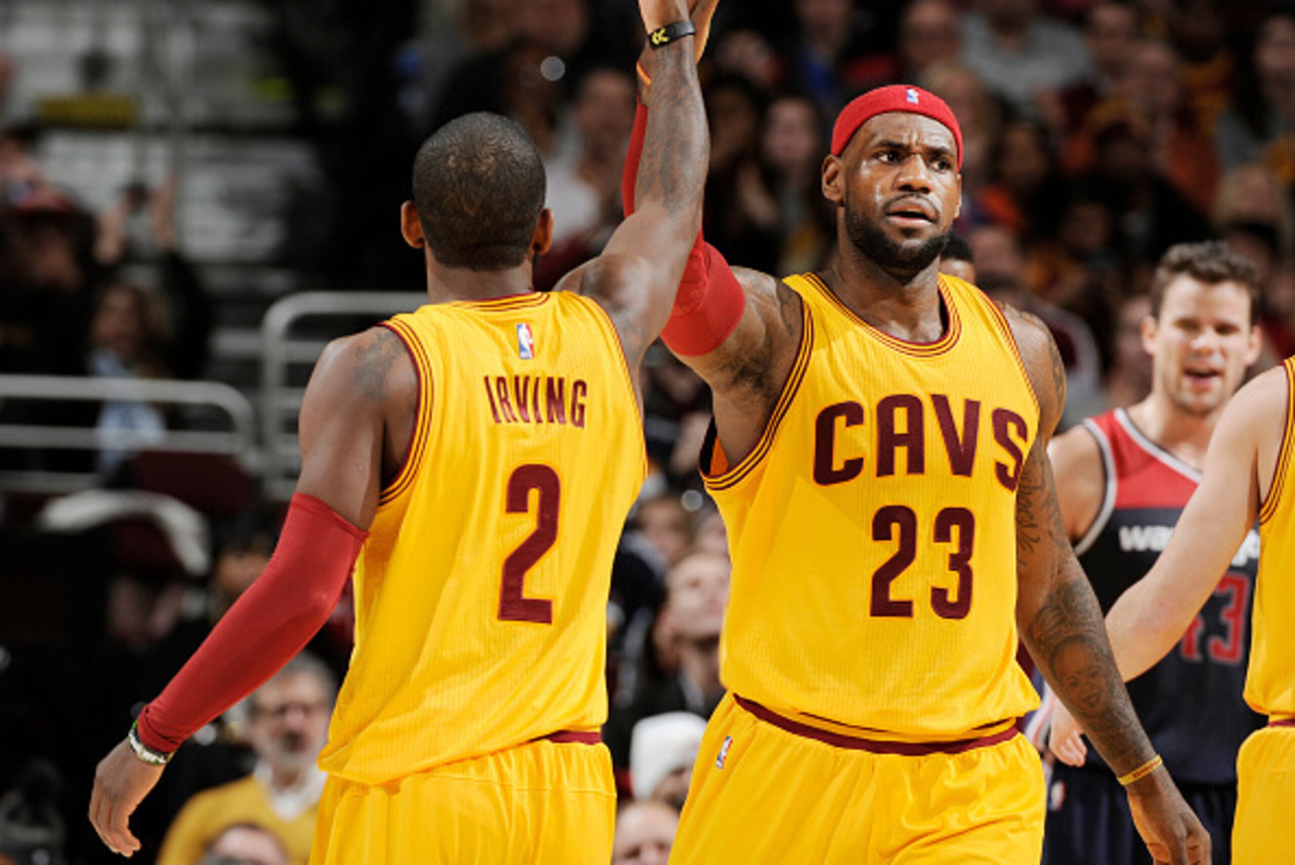 CLEVELAND, OH - NOVEMBER 26: LeBron James #23 high fives teammate Kyrie Irving #2 of the Cleveland Cavaliers during the game against the Washington Wizards on November 26, 2014 at Quicken Loans Arena in Cleveland, Ohio. NOTE TO USER: User expressly ackno CLEVELAND, OH - NOVEMBER 26: LeBron James #23 high fives teammate Kyrie Irving #2 of the Cleveland Cavaliers during the game against the Washington Wizards on November 26, 2014 at Quicken Loans Arena in Cleveland, Ohio. NOTE TO USER: User expressly ackno