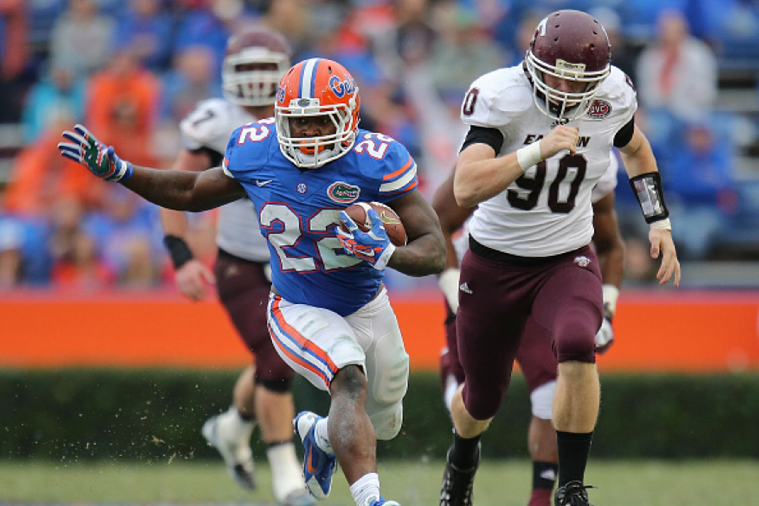GAINESVILLE, FL - NOVEMBER 22: Adam Lane #22 of the Florida Gators carries past defender Robby Irgang #90 of the Eastern Kentucky Colonels of the game at Ben Hill Griffin Stadium on November 22, 2014 in Gainesville, Florida.  (Photo by Rob Foldy/Getty Ima