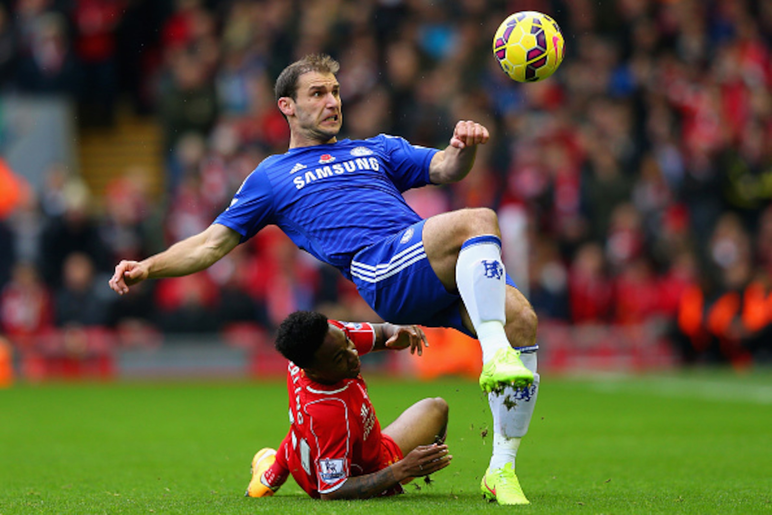 LIVERPOOL, ENGLAND - NOVEMBER 08:  Branislav Ivanovic of Chelsea and Raheem Sterling of Liverpool battle for the ball during the Barclays Premier League match between Liverpool and Chelsea at Anfield on November 8, 2014 in Liverpool, England.  (Photo by A