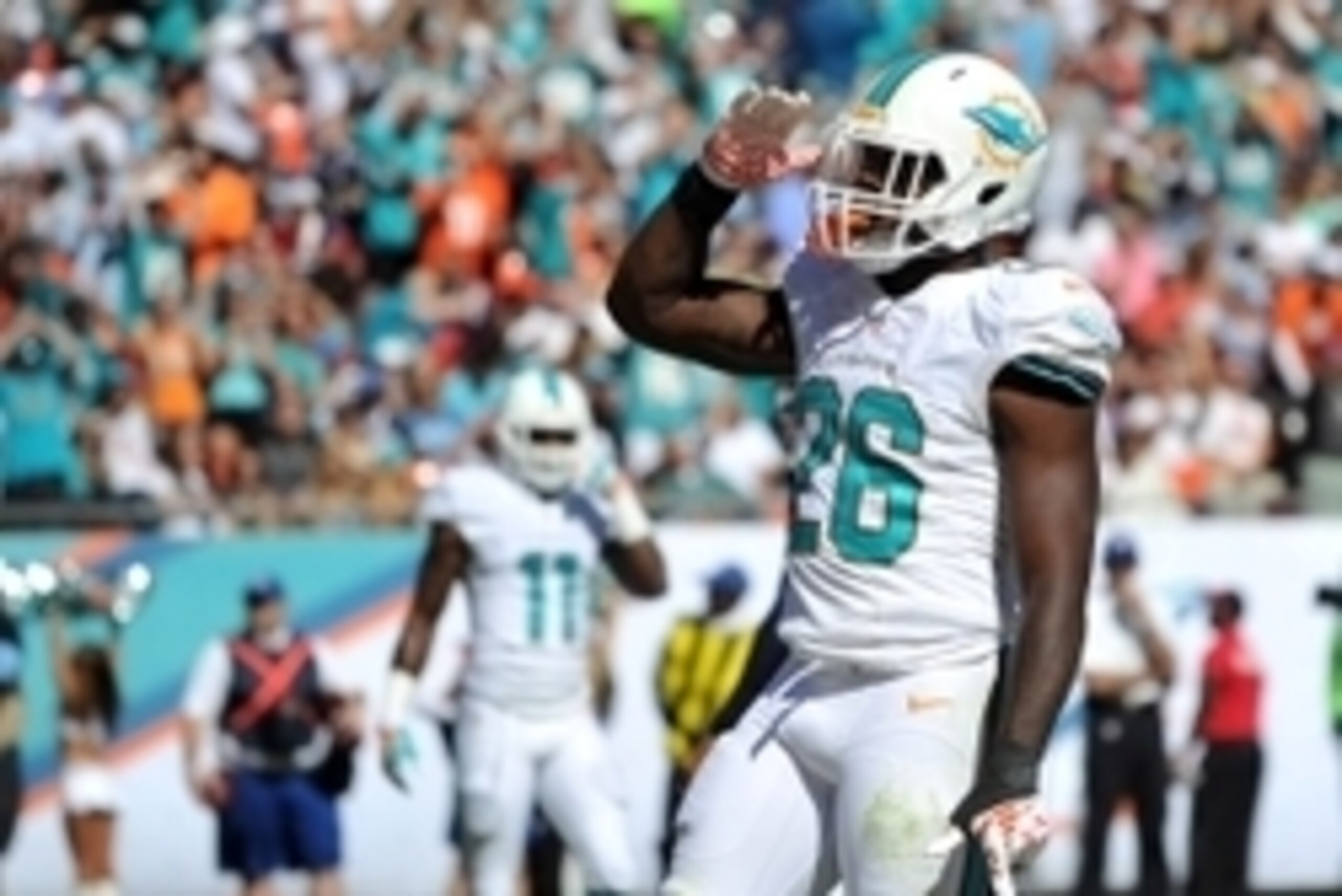 Nov 2, 2014; Miami Gardens, FL, USA; Miami Dolphins running back Lamar Miller (26) celebrates after scoring a touchdown against the San Diego Chargers during the first half at Sun Life Stadium. Mandatory Credit: Steve Mitchell-USA TODAY Sports