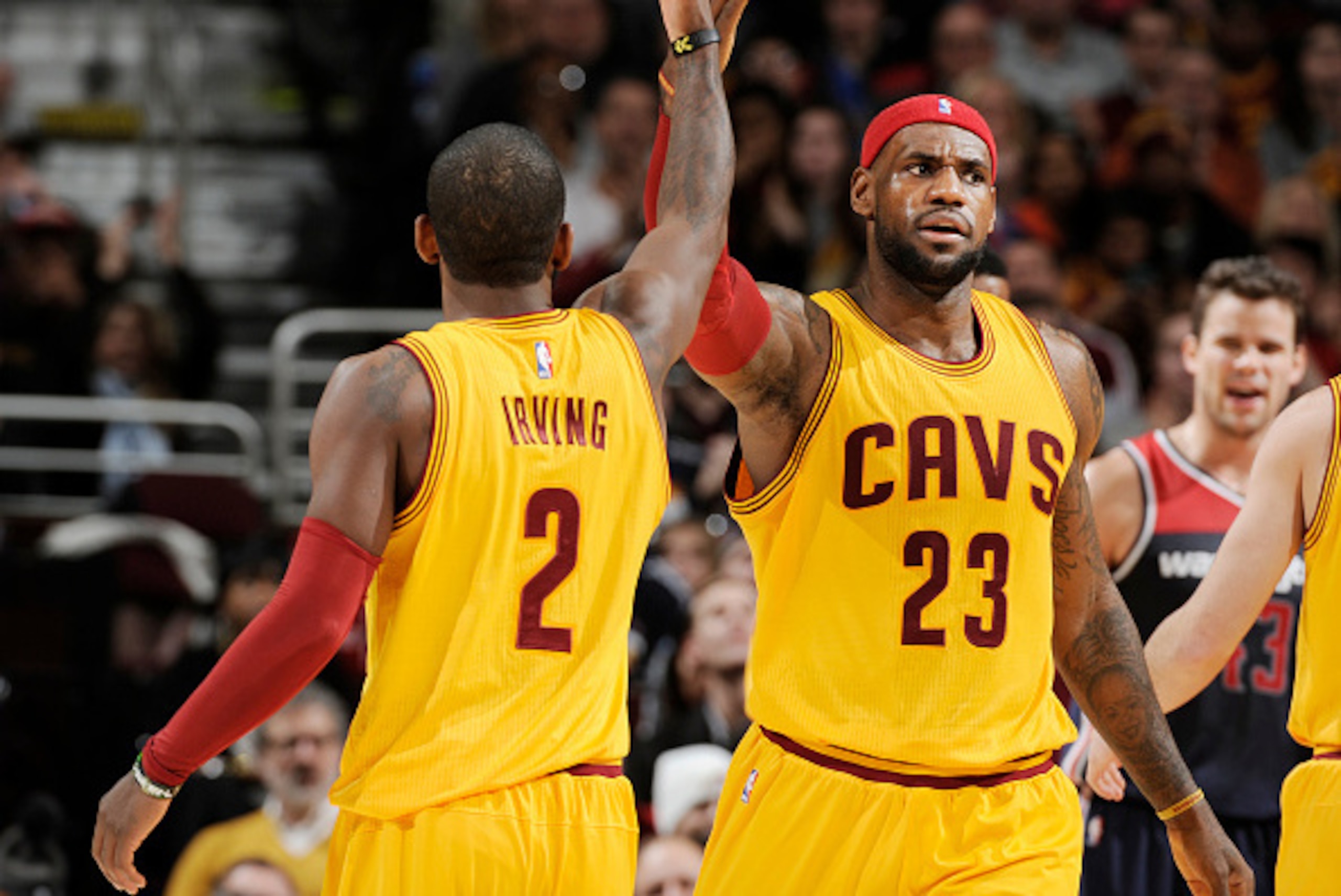CLEVELAND, OH - NOVEMBER 26: LeBron James #23 high fives teammate Kyrie Irving #2 of the Cleveland Cavaliers during the game against the Washington Wizards on November 26, 2014 at Quicken Loans Arena in Cleveland, Ohio. NOTE TO USER: User expressly ackno CLEVELAND, OH - NOVEMBER 26: LeBron James #23 high fives teammate Kyrie Irving #2 of the Cleveland Cavaliers during the game against the Washington Wizards on November 26, 2014 at Quicken Loans Arena in Cleveland, Ohio. NOTE TO USER: User expressly ackno