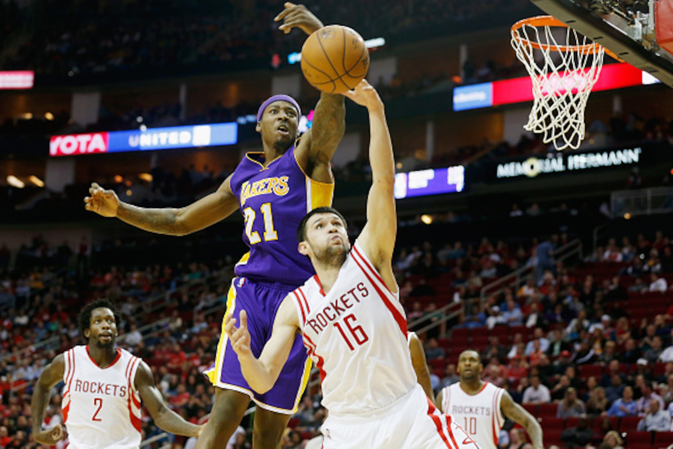 HOUSTON, TX - NOVEMBER 19:  Ed Davis #21 of the Los Angeles Lakers fights for a rebound against Kostas Papanikolaou #16 of the Houston Rockets during their game at the Toyota Center on November 19, 2014 in Houston, Texas.  NOTE TO USER: User expressly ack