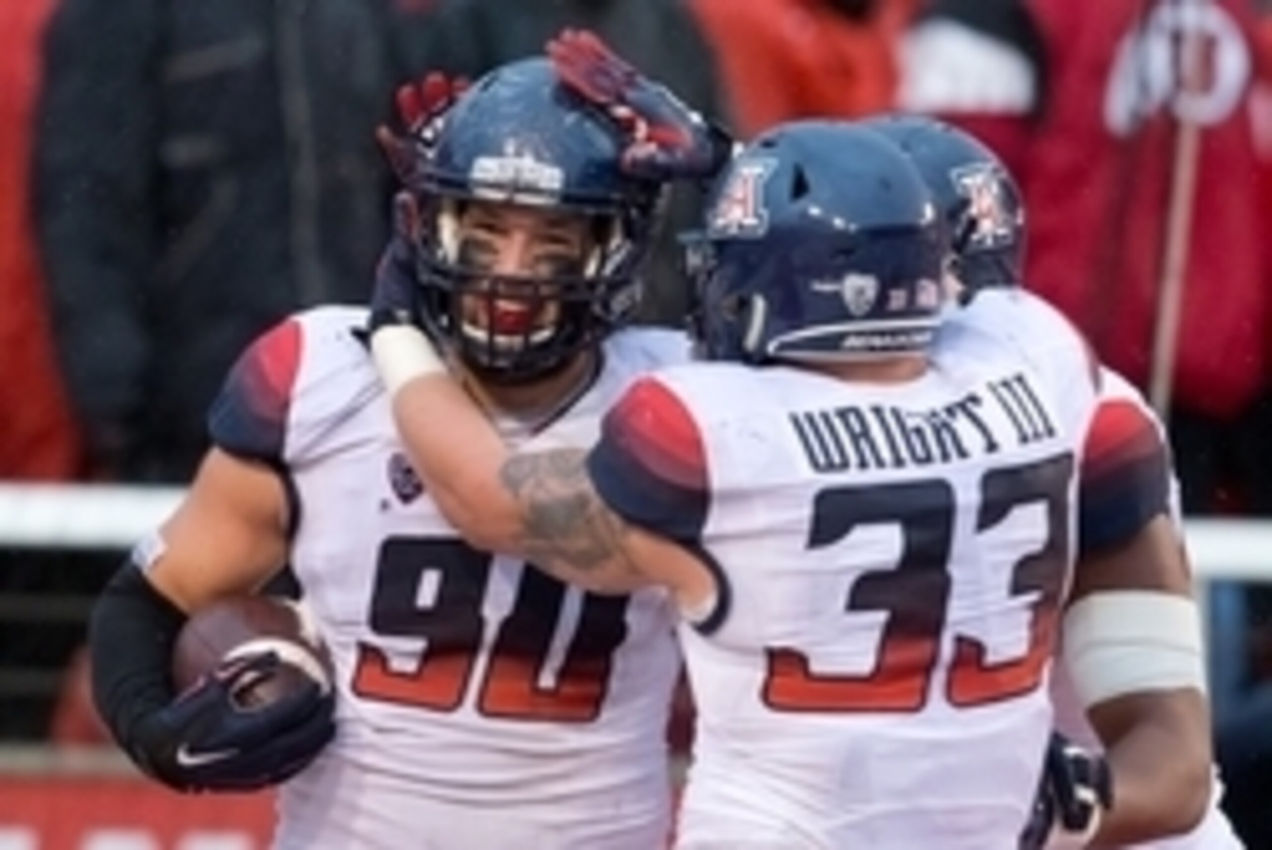 Nov 22, 2014; Salt Lake City, UT, USA; Arizona Wildcats linebacker Scooby Wright III (33) and defensive lineman Dan Pettinato (90) react to a touchdown by Pettinato during the first half against the Utah Utes at Rice-Eccles Stadium. Mandatory Credit: Russ